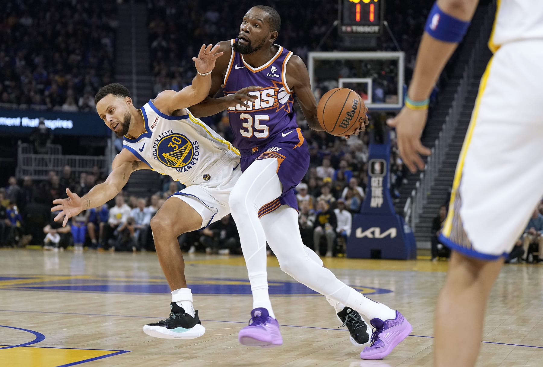 SAN FRANCISCO, CALIFORNIA - OCTOBER 24: Kevin Durant #35 of the Phoenix Suns drives on Stephen Curry #30 of the Golden State Warriors during the first quarter at Chase Center on October 24, 2023 in San Francisco, California. NOTE TO USER: User expressly acknowledges and agrees that, by downloading and or using this photograph, User is consenting to the terms and conditions of the Getty Images License Agreement. (Photo by Thearon W. Henderson/Getty Images)
