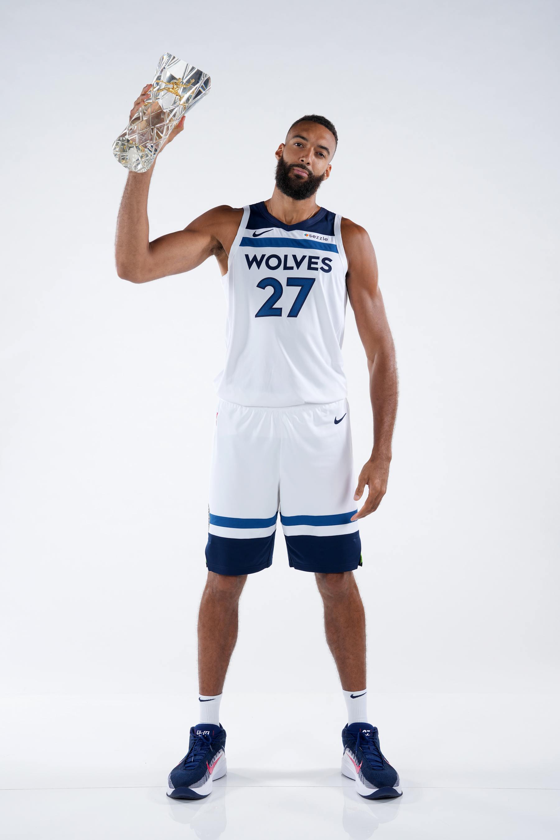 MINNEAPOLIS, MN - SEPTEMBER 30: Rudy Gobert #27 of the Minnesota Timberwolves poses for a portrait with the 2023-24 KIA Hakeem Olajuwon NBA Defensive Player of the Year Award during NBA Media Day on September 30, 2024 at Target Center in Minneapolis, Minnesota. NOTE TO USER: User expressly acknowledges and agrees that, by downloading and or using this photograph, User is consenting to the terms and conditions of the Getty Images License Agreement. Mandatory Copyright Notice: Copyright 2024 NBAE (Photo by Jordan Johnson/NBAE via Getty Images)