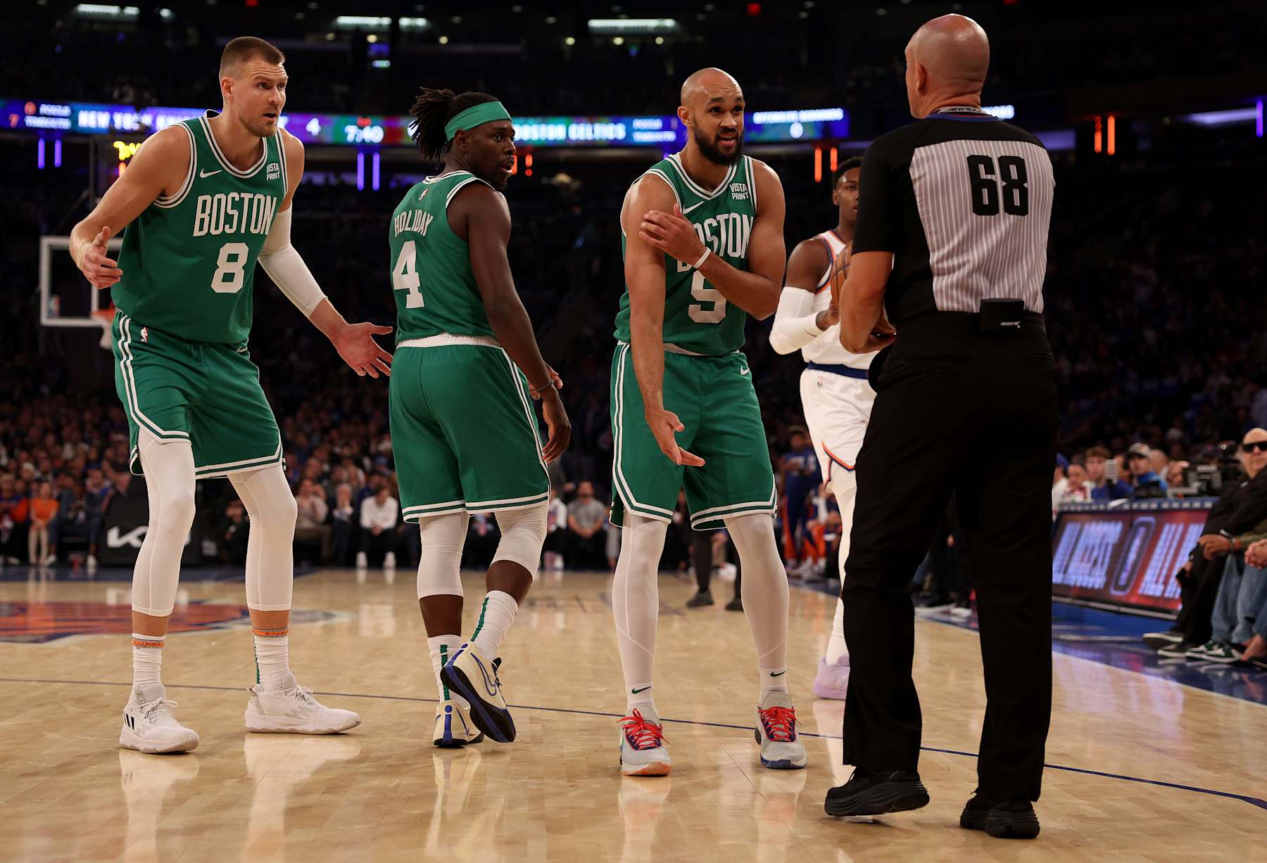 NEW YORK, NEW YORK - OCTOBER 25:  Derrick White #9 of the Boston Celtics reacts after he is called for an offensive foul in the first quarter against the New York Knicks at Madison Square Garden on October 25, 2023 in New York City. Teammates Kristaps Porzingis #8 and Jrue Holiday #4 of the Boston Celtics support. NOTE TO USER: User expressly acknowledges and agrees that, by downloading and or using this photograph, User is consenting to the terms and conditions of the Getty Images License Agreement. (Photo by Elsa/Getty Images)