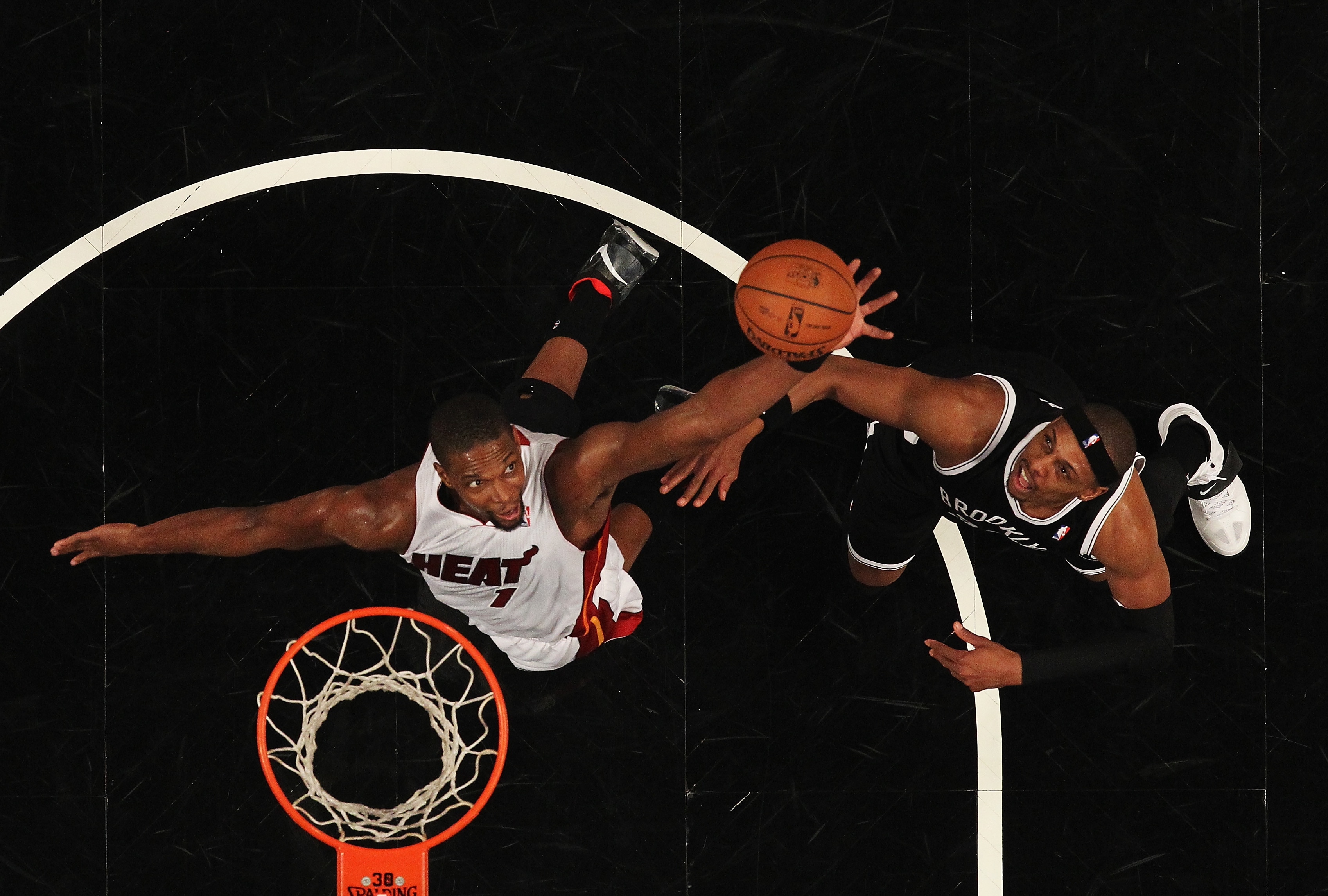 NEW YORK, NY - JANUARY 10:  Chris Bosh #1 of the Miami Heat and Paul Pierce #34 of the Brooklyn Nets battle for the ball during their game at the Barclays Center on January 10, 2014 in New York City.  NOTE TO USER: User expressly acknowledges and agrees that, by downloading and or using this photograph, User is consenting to the terms and conditions of the Getty Images License Agreement.  (Photo by Al Bello/Getty Images)