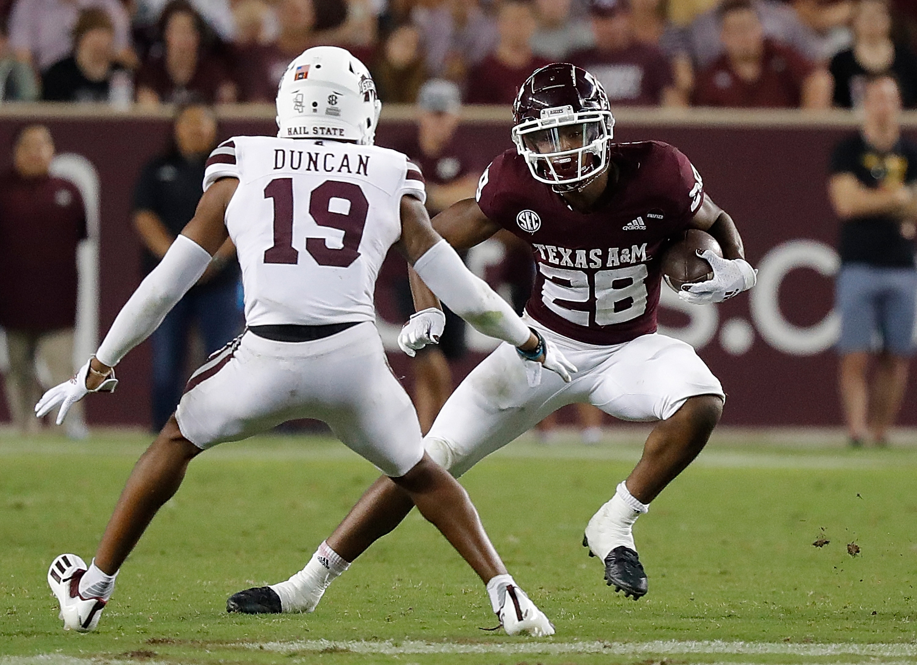 COLLEGE STATION, TEXAS - OCTOBER 02: Isaiah Spiller #28 of the Texas A&M Aggies looks to avoid the tackle of Collin Duncan #19 of the Mississippi State Bulldogs at Kyle Field on October 02, 2021 in College Station, Texas. (Photo by Bob Levey/Getty Images)