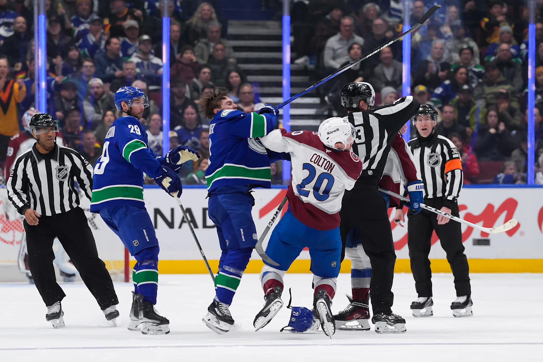VANCOUVER, CANADA - FEBRUARY 4: Ross Colton #20 of the Colorado Avalanche is checked by Nils Hoglander #21 of the Vancouver Canucks during the third period at Rogers Arena on February 4, 2025 in Vancouver, British Columbia, Canada. (Photo by Derek Cain/Getty Images)