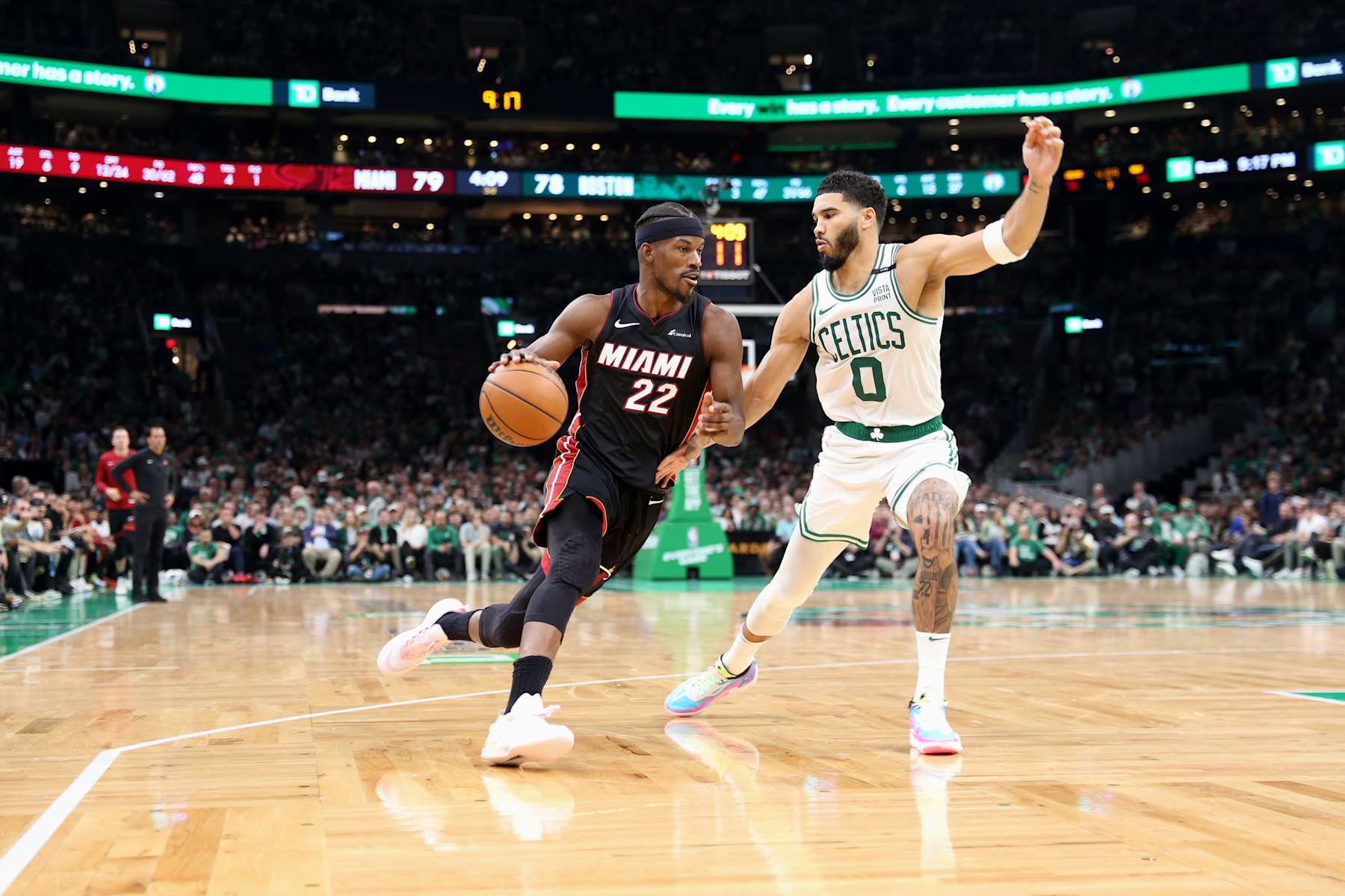 BOSTON, MASSACHUSETTS - OCTOBER 27: Jimmy Butler #22 of the Miami Heat drives to the basket against Jayson Tatum #0 of the Boston Celtics at TD Garden on October 27, 2023 in Boston, Massachusetts. NOTE TO USER: User expressly acknowledges and agrees that, by downloading and or using this photograph, User is consenting to the terms and conditions of the Getty Images License Agreement. (Photo by Maddie Schroeder/Getty Images)