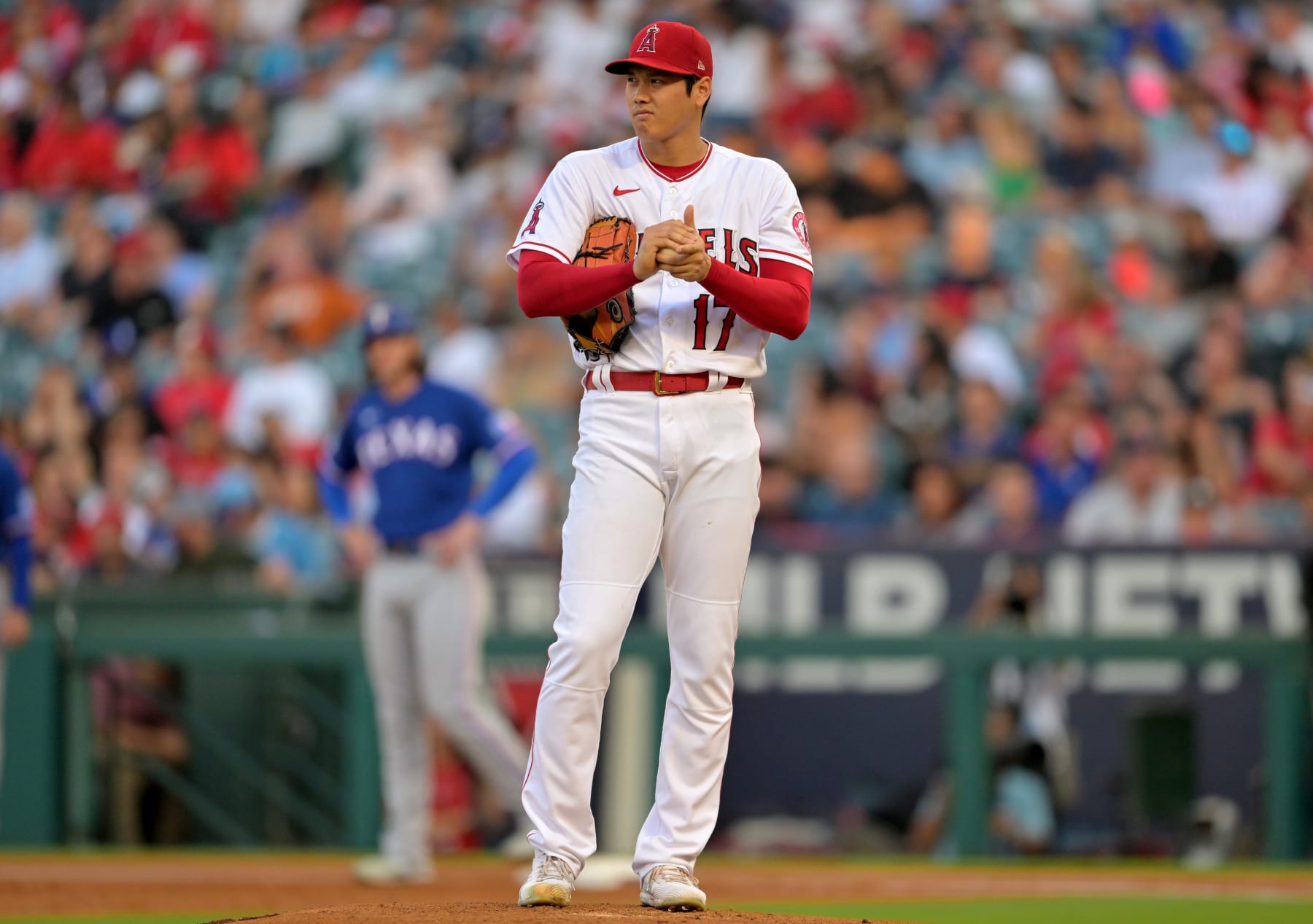 ANAHEIM, CA - JULY 28: Shohei Ohtani #17 of the Los Angeles Angels rubs the ball as he stands on the mound in the game against the Texas Rangers at Angel Stadium of Anaheim on July 28, 2022 in Anaheim, California. (Photo by Jayne Kamin-Oncea/Getty Images)