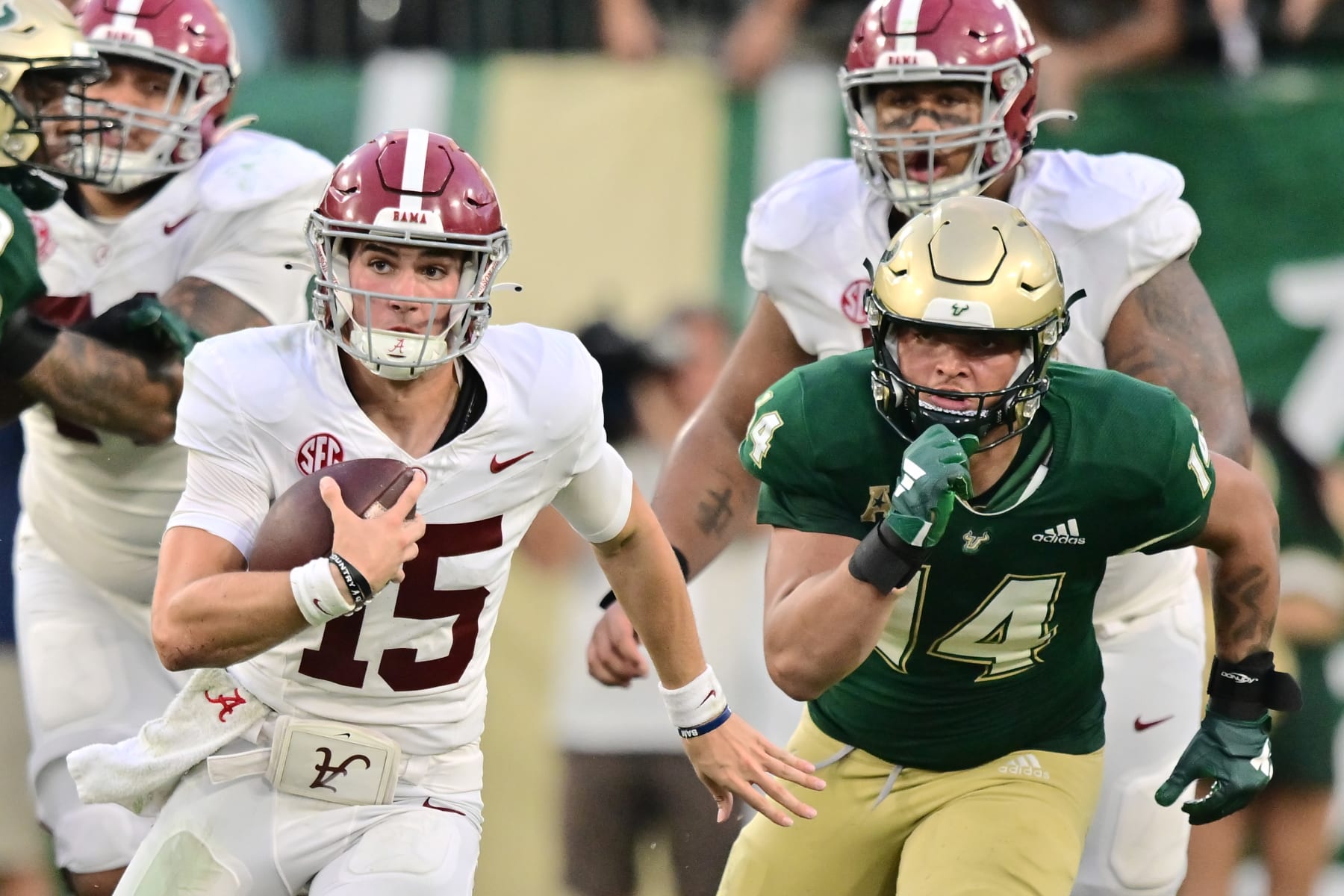 TAMPA, FLORIDA - SEPTEMBER 16: Ty Simpson #15 of the Alabama Crimson Tide rushes the ball against Michael Williams II #14 of the South Florida Bulls in the fourth quarter at Raymond James Stadium on September 16, 2023 in Tampa, Florida. (Photo by Julio Aguilar/Getty Images)