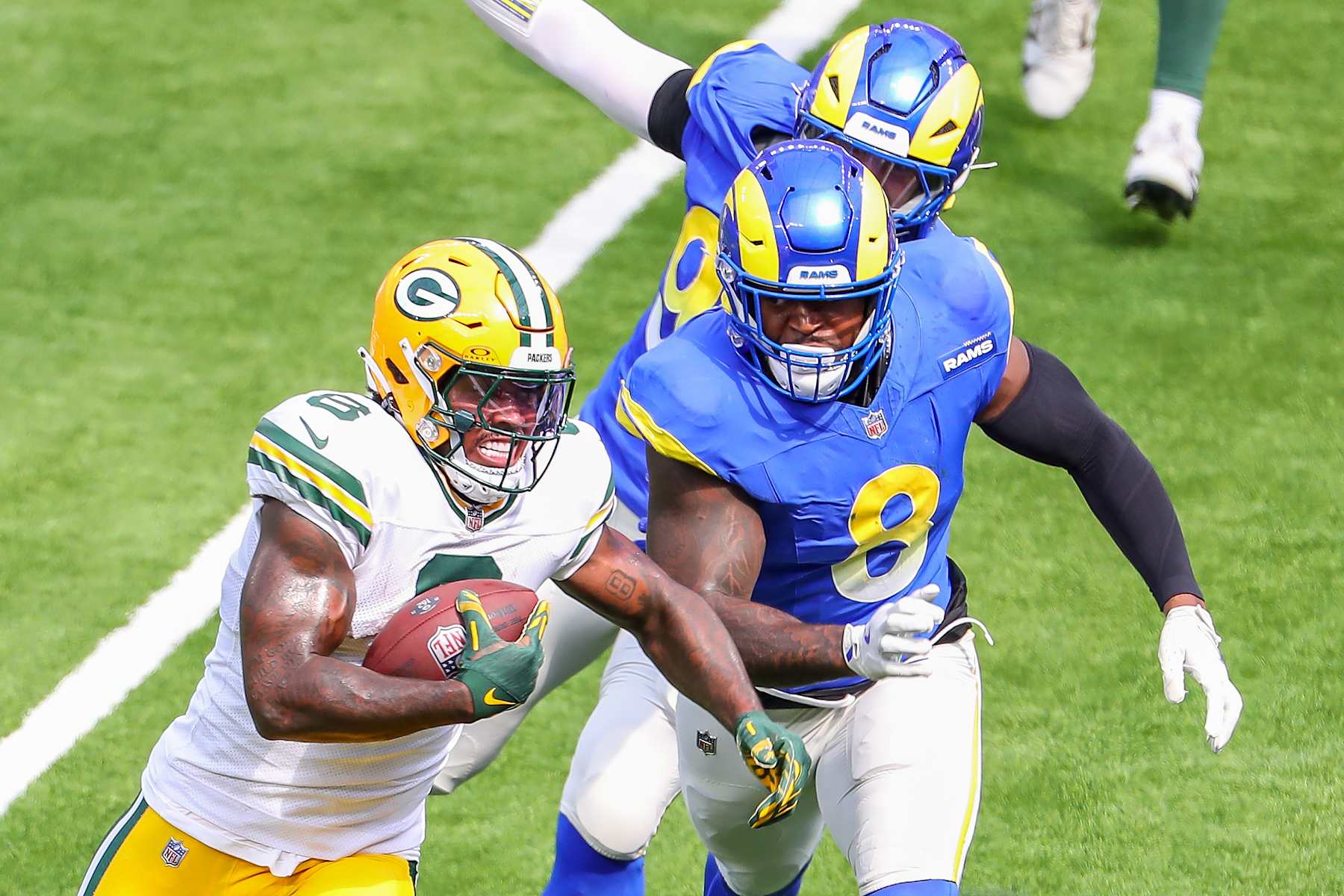 INGLEWOOD, CA - OCTOBER 6:Green Bay Packers wide receiver Christian Watson (9) runs away Los Angeles Rams linebacker Jared Verse (8) during the NFL game between the Green Bay Packers and the Los Angeles Rams on October 06, 2024,  at SoFi Stadium in Inglewood, CA. (Photo by Jevone Moore/Icon Sportswire via Getty Images)