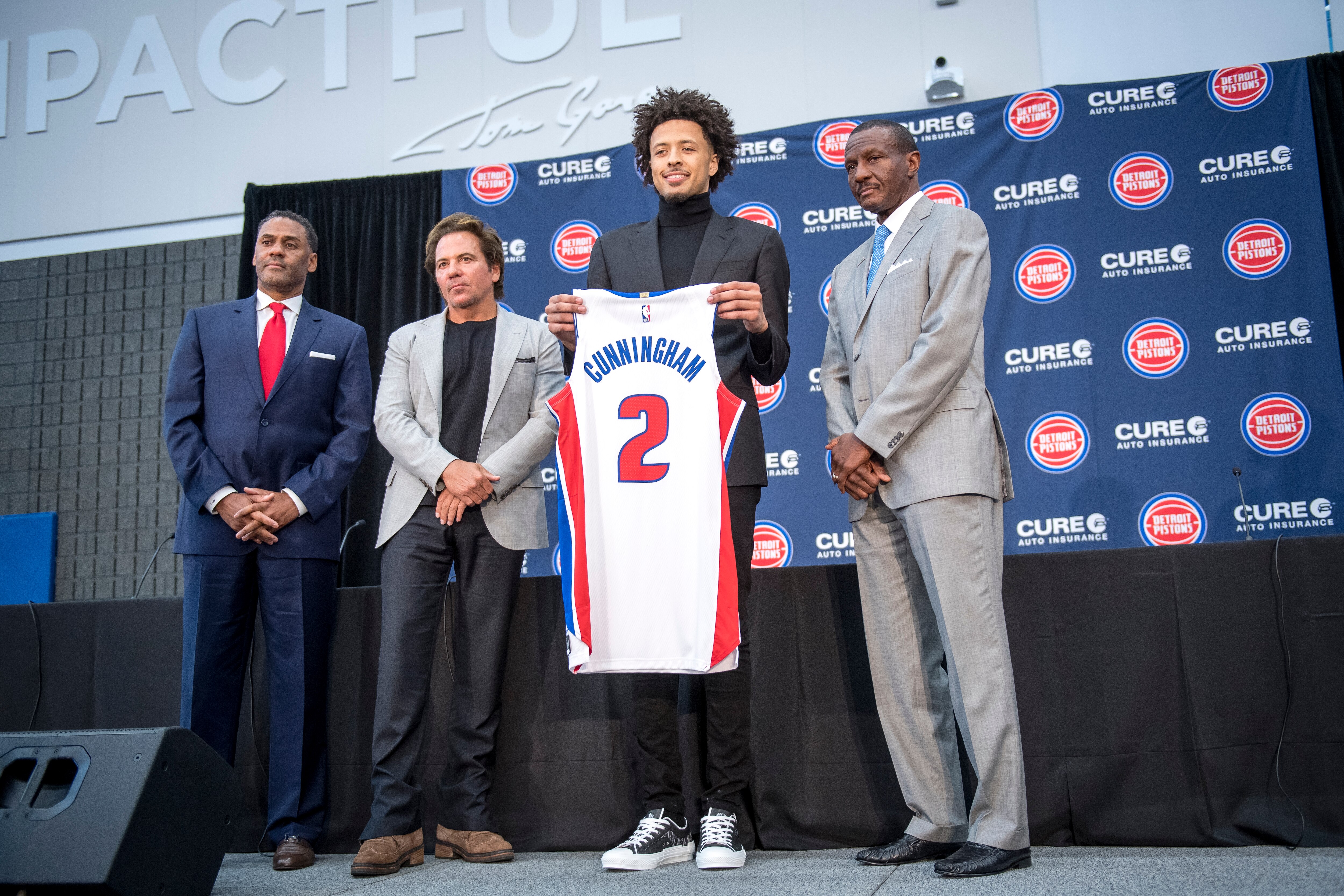 DETROIT, MICHIGAN - JULY 30: From left, Detroit Pistons general manager Troy Weaver, owner Tom Gores, draft pick Cade Cunningham and head coach Dwane Casey pose for a photo after the press conference on July 30, 2021 at the Pistons Performance Center in Detroit, Michigan. (Photo by Nic Antaya/Getty Images)