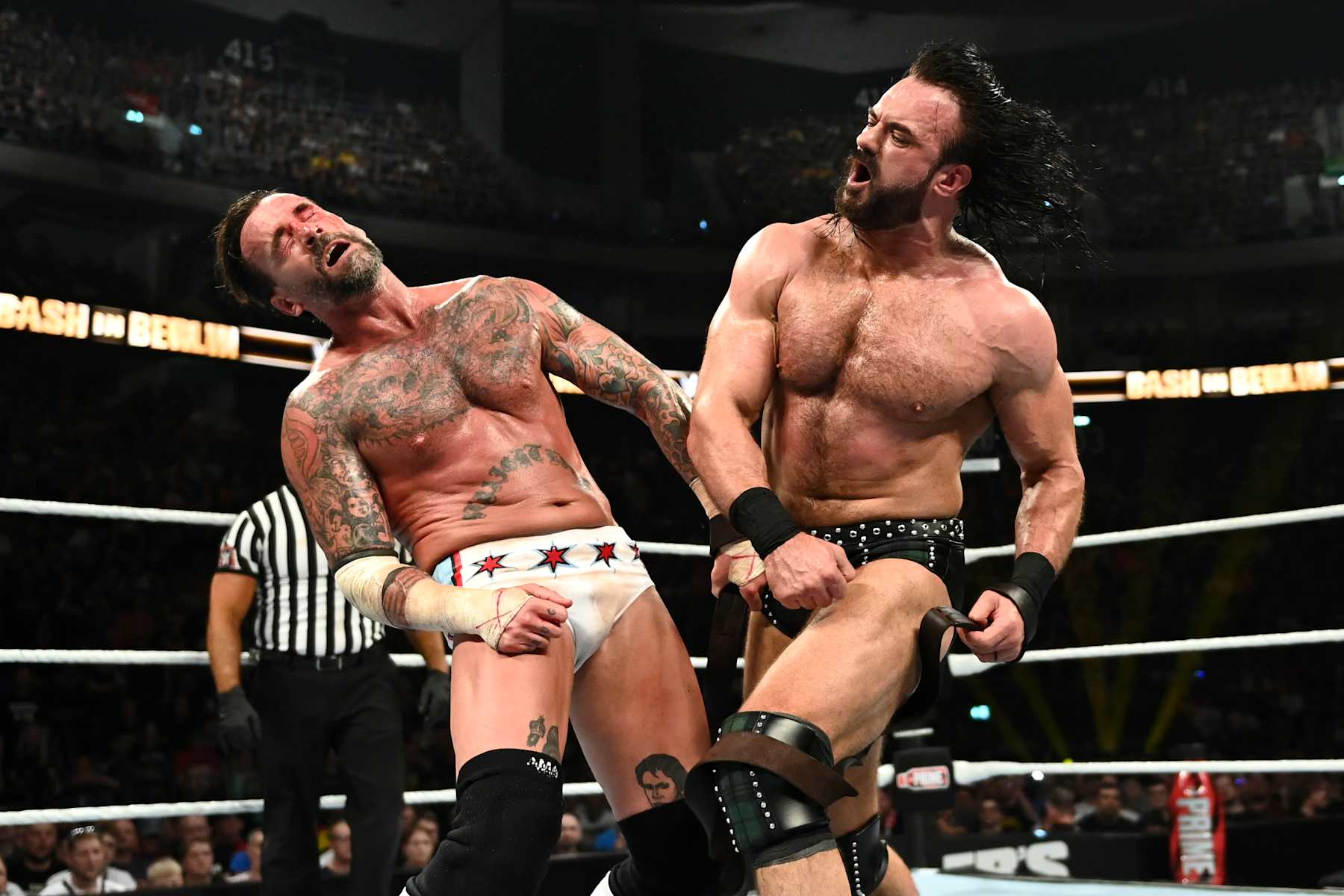 BERLIN, GERMANY - AUGUST 31: Drew McIntyre (R) connects with a punch against CM Punk during their strap match at the WWE Bash in Berlin Premium Live Event at Uber Arena on August 31, 2024 in Berlin, Germany.  (Photo by WWE/Getty Images)