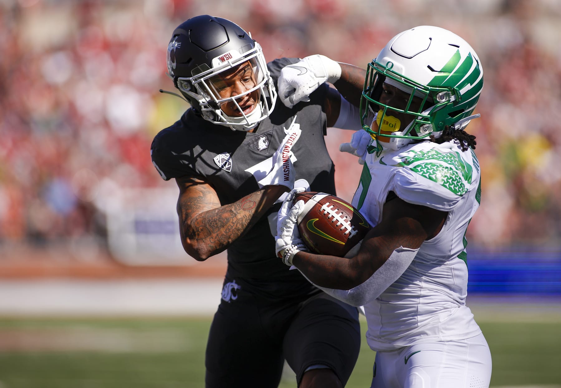 PULLMAN, WA - SEPTEMBER 24: DUPLICATE***Oregon Ducks running back Mar'Keise Irving (0)***Oregon Ducks defensive back Christian Gonzalez (0) attempts to shed off Washington State Cougars defensive back Derrick Langford Jr. (5) during the Washington State Cougars versus the Oregon Ducks game on Saturday September 24, 2022 at Martin Stadium in Pullman, WA. (Photo by Oliver McKenna/Icon Sportswire via Getty Images)