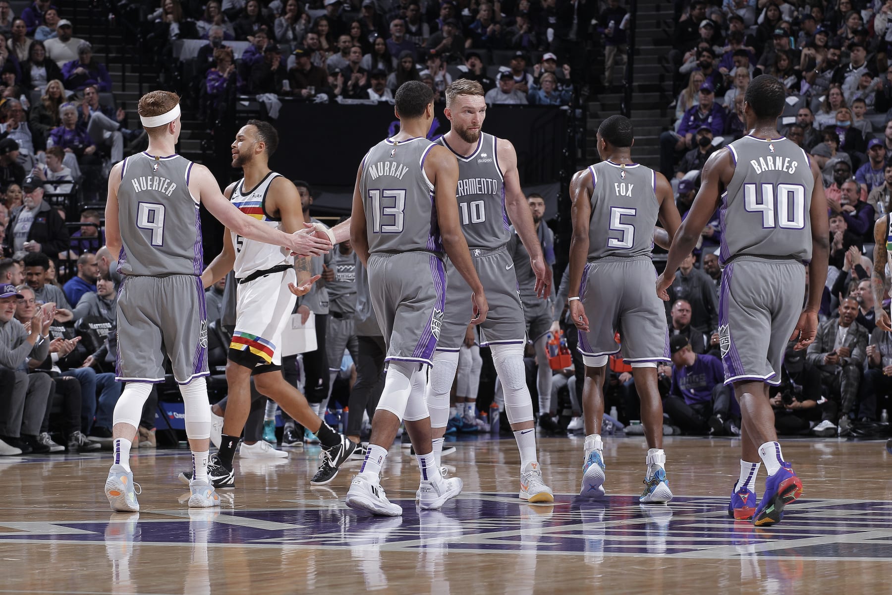 SACRAMENTO, CA - MARCH 27: Domantas Sabonis #10 of the Sacramento Kings high fives teammates Kevin Huerter #9, Keegan Murray #13, DeAaron Fox #5, and Harrison Barnes #40 during a timeout in a game against the Minnesota Timberwolves on March 27, 2023 at Golden 1 Center in Sacramento, California. NOTE TO USER: User expressly acknowledges and agrees that, by downloading and or using this photograph, User is consenting to the terms and conditions of the Getty Images Agreement. Mandatory Copyright Notice: Copyright 2023 NBAE (Photo by Rocky Widner/NBAE via Getty Images)