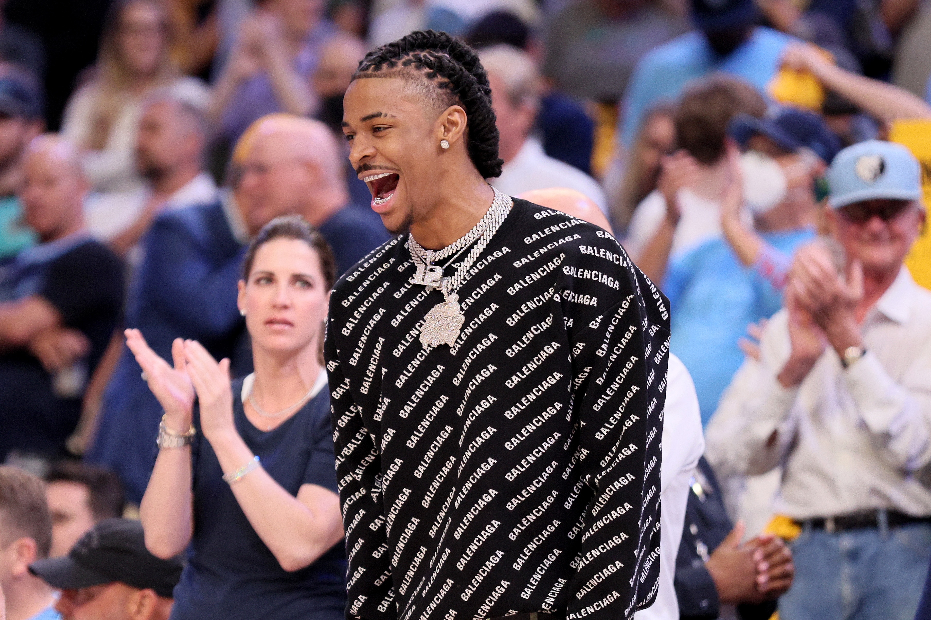 MEMPHIS, TENNESSEE - MAY 11: Ja Morant #12 of the Memphis Grizzlies reacts to a basket from the bench against the Golden State Warriors during the first quarter in Game Five of the 2022 NBA Playoffs Western Conference Semifinals at FedExForum on May 11, 2022 in Memphis, Tennessee. NOTE TO USER: User expressly acknowledges and agrees that, by downloading and/or using this photograph, User is consenting to the terms and conditions of the Getty Images License Agreement. (Photo by Andy Lyons/Getty Images)