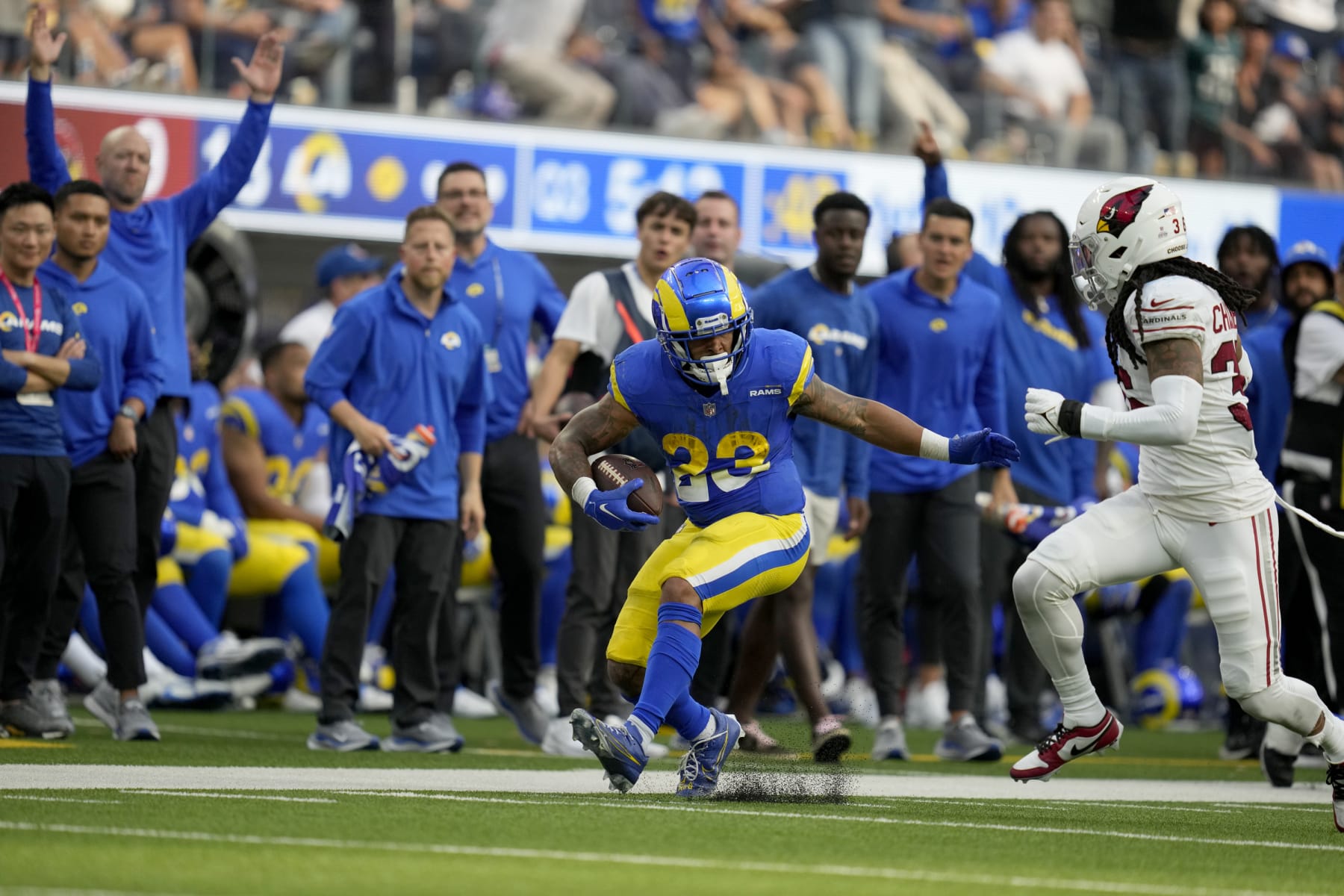 Los Angeles Rams running back Kyren Williams (23) is chased by Arizona Cardinals safety Andre Chachere (36) during the second half of an NFL football game Sunday, Oct. 15, 2023, in Inglewood, Calif. (AP Photo/Ashley Landis)
