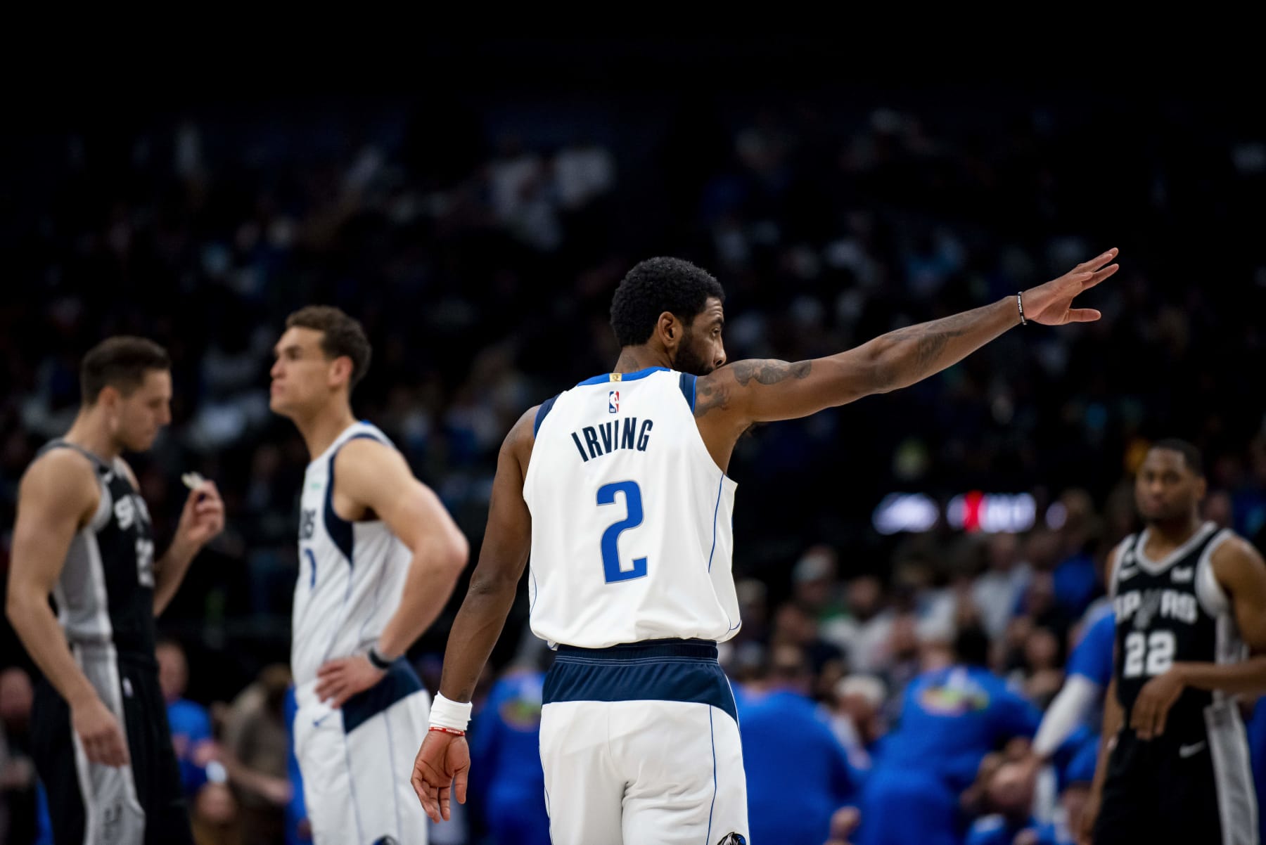 Dallas Mavericks guard Kyrie Irving (2) waves to a fan in the stands in the first half of an NBA basketball game against the San Antonio Spurs on Thursday, Feb. 23, 2023, in Dallas. (AP Photo/Emil T. Lippe)