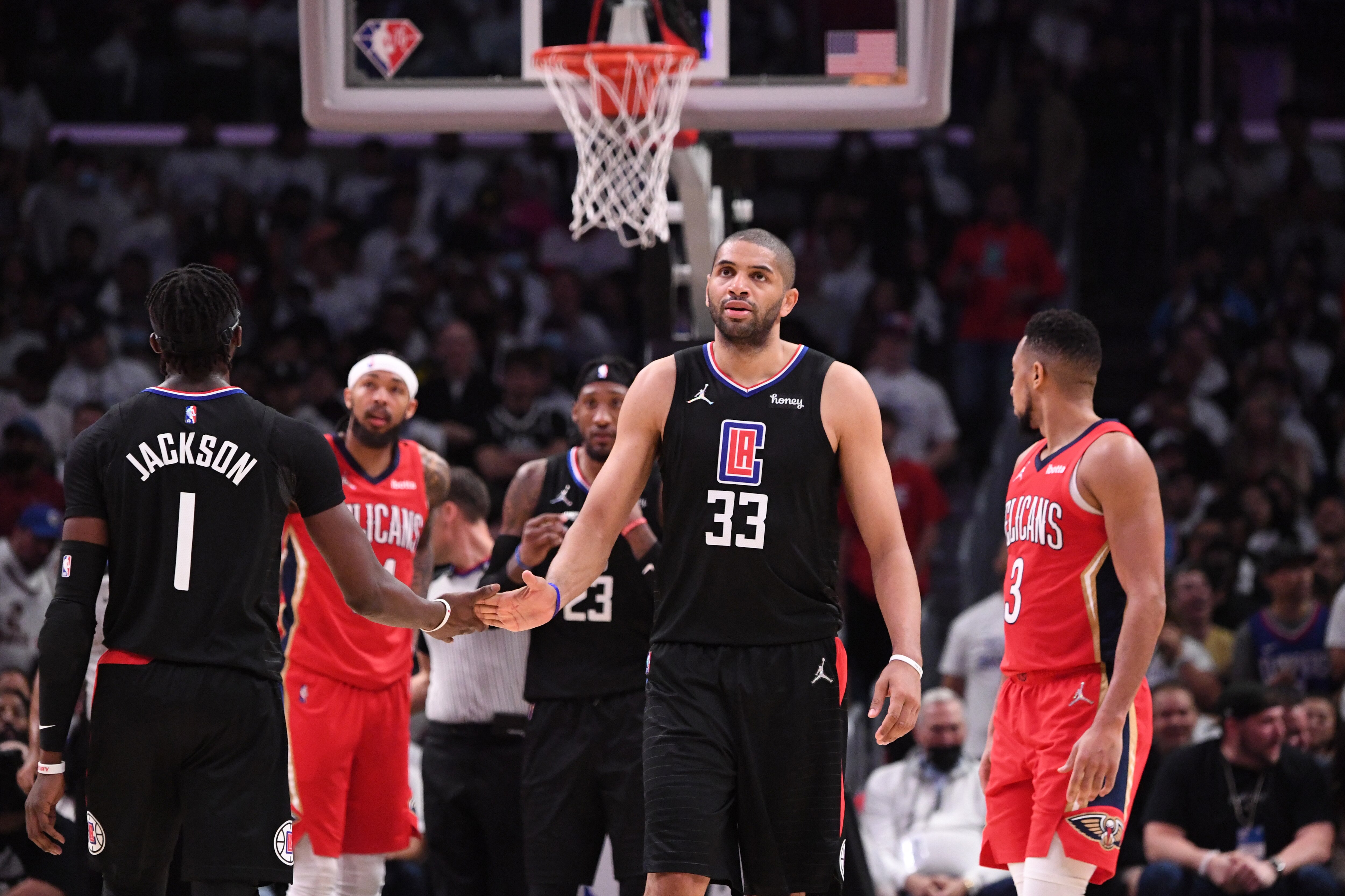 LOS ANGELES, CA - APRIL 15: Reggie Jackson #1 of the LA Clippers high fives Nicolas Batum #33 against the New Orleans Pelicans during the 2022 play-in tournament on April 15, 2022 at Crypto.Com Arena in Los Angeles, California. NOTE TO USER: User expressly acknowledges and agrees that, by downloading and/or using this Photograph, user is consenting to the terms and conditions of the Getty Images License Agreement. Mandatory Copyright Notice: Copyright 2022 NBAE (Photo by Adam Pantozzi/NBAE via Getty Images)