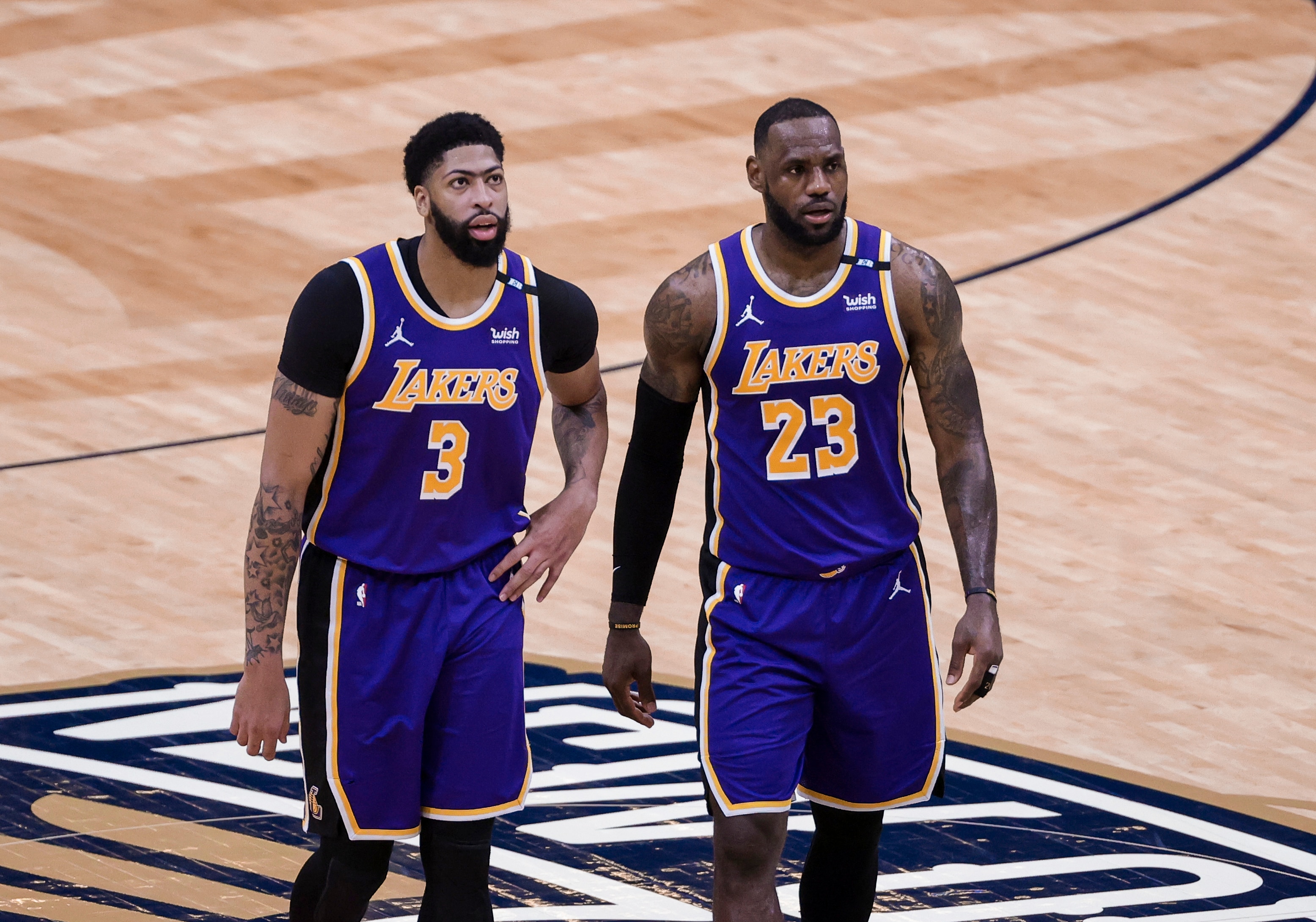 Los Angeles Lakers forward LeBron James (23) and forward Anthony Davis (3) during a time out in the second quarter of an NBA basketball game against the New Orleans Pelicans in New Orleans, Sunday, May 16, 2021. (AP Photo/Derick Hingle)