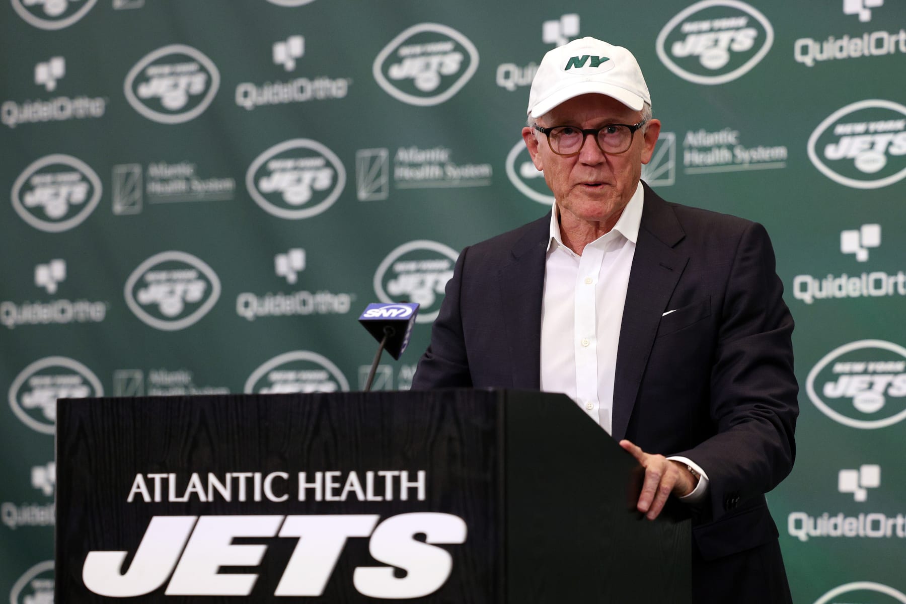 FLORHAM PARK, NEW JERSEY - APRIL 26: New York Jets owner Woody Johnson speaks during an introductory press conference for quarterback Aaron Rodgers at Atlantic Health Jets Training Center on April 26, 2023 in Florham Park, New Jersey. (Photo by Elsa/Getty Images)