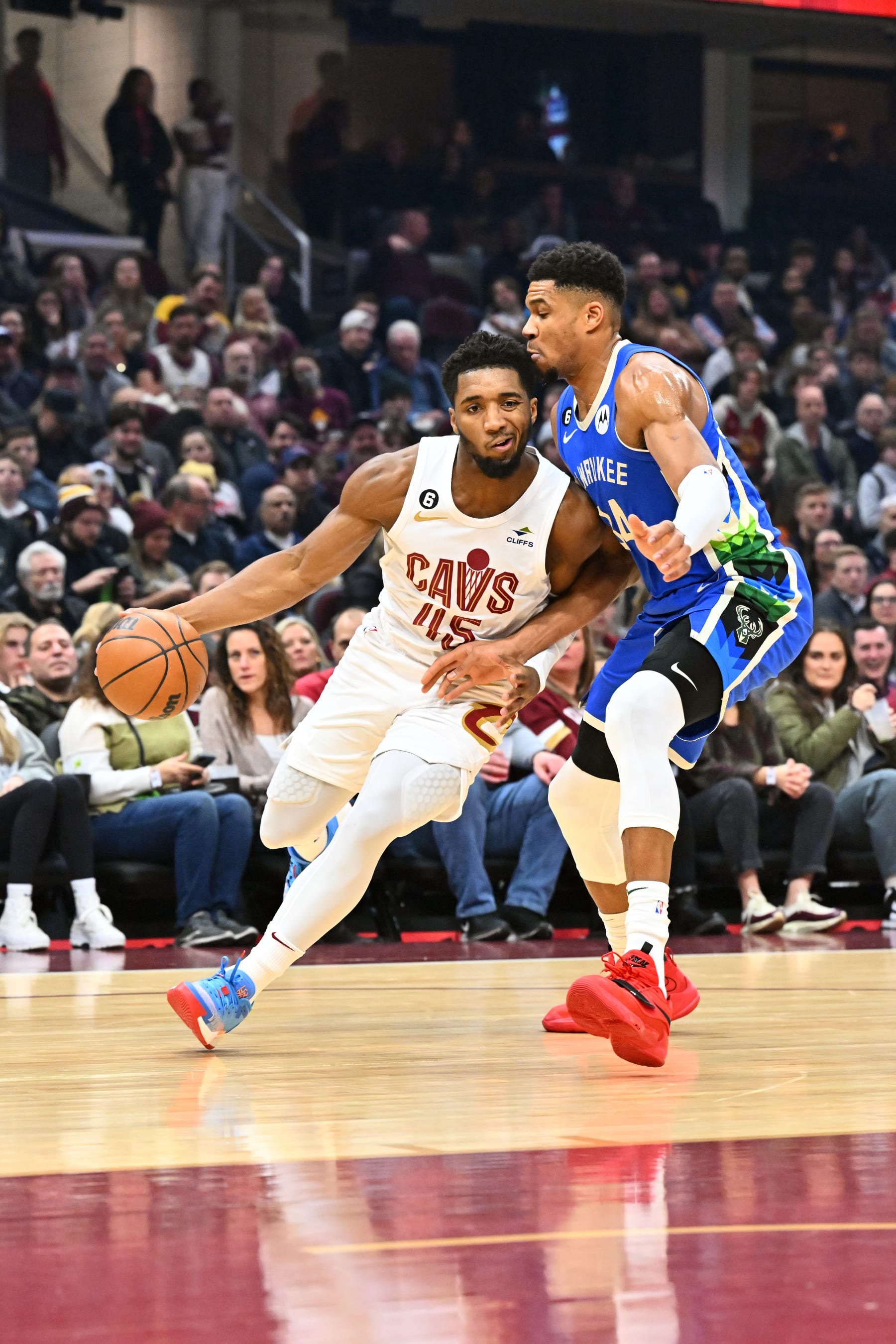 CLEVELAND, OHIO - DECEMBER 21: Donovan Mitchell #45 of the Cleveland Cavaliers dribbles the ball to the basket around Giannis Antetokounmpo #34 of the Milwaukee Bucks during the first quarter at Rocket Mortgage Fieldhouse on December 21, 2022 in Cleveland, Ohio. NOTE TO USER: User expressly acknowledges and agrees that, by downloading and or using this photograph, User is consenting to the terms and conditions of the Getty Images License Agreement. (Photo by Jason Miller/Getty Images)