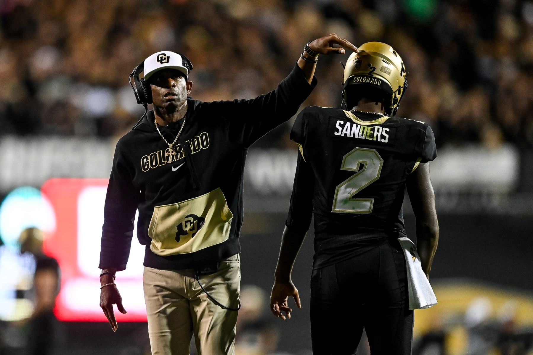 BOULDER, CO - SEPTEMBER 16:  Head coach Deion Sanders of the Colorado Buffaloes celebrates with quarterback Shedeur Sanders #2 after a fourth quarter touchdown against the Colorado State Rams at Folsom Field on September 16, 2023 in Boulder, Colorado. (Photo by Dustin Bradford/Getty Images)