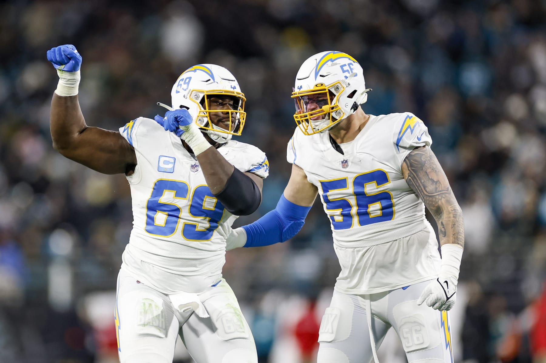 JACKSONVILLE, FL - JANUARY 14: Los Angeles Chargers defensive tackle Sebastian Joseph-Day (69) and Los Angeles Chargers defensive end Morgan Fox (56) reacts after a play during the game between the Los Angeles Chargers and the Jacksonville Jaguars on January 14, 2023 at TIAA Bank Field in Jacksonville, Fl. (Photo by David Rosenblum/Icon Sportswire via Getty Images)