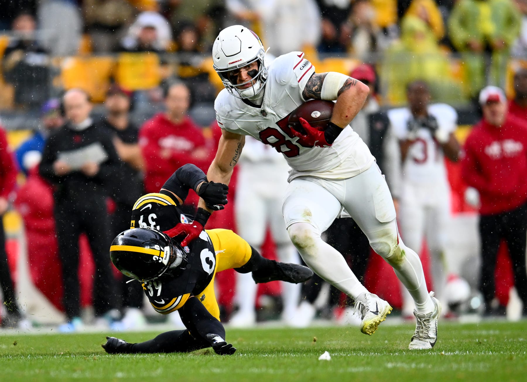 PITTSBURGH, PENNSYLVANIA - DECEMBER 03: Trey McBride #85 of the Arizona Cardinals avoids a tackle from Minkah Fitzpatrick #39 of the Pittsburgh Steelers during the second quarter at Acrisure Stadium on December 03, 2023 in Pittsburgh, Pennsylvania. (Photo by Joe Sargent/Getty Images)