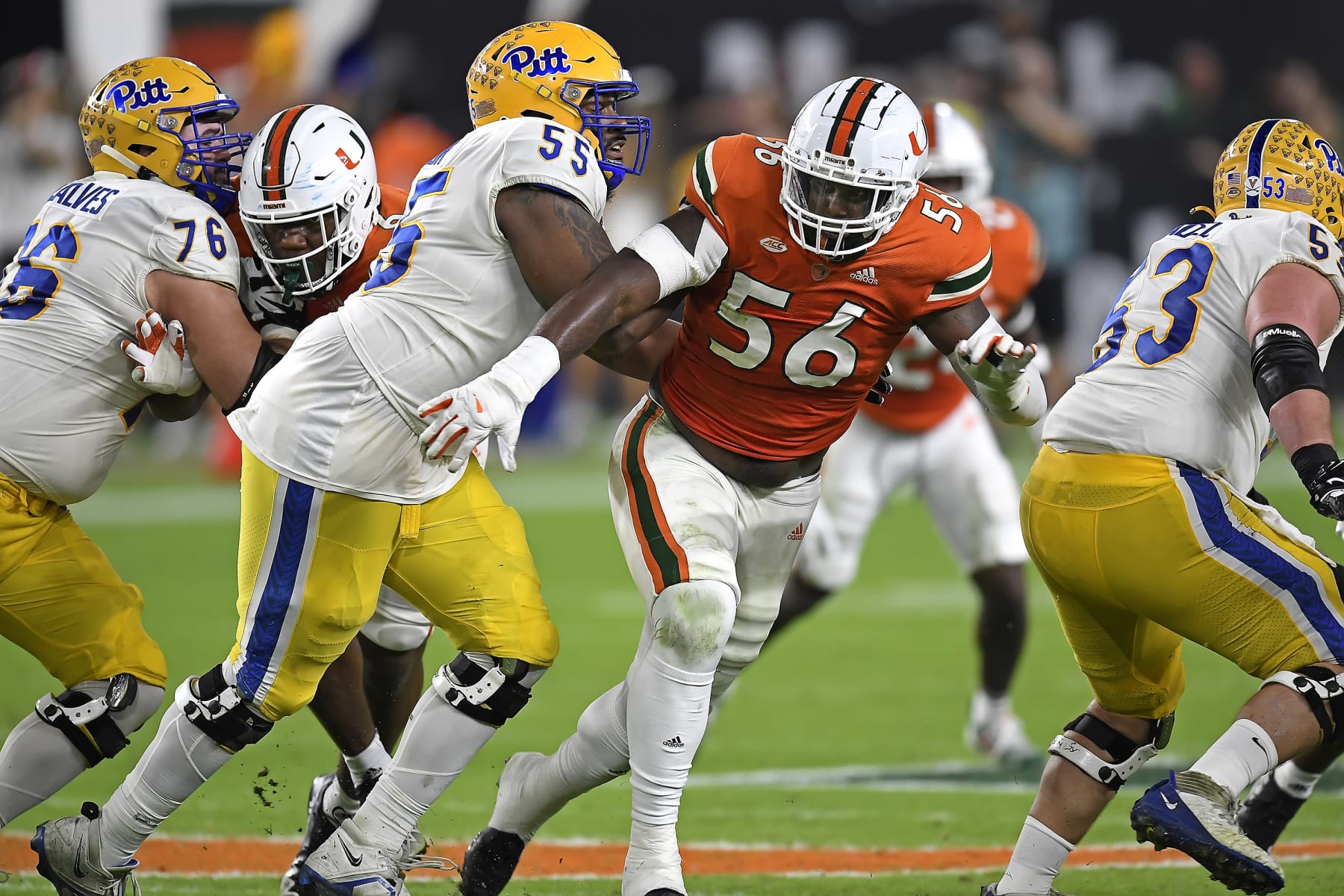 MIAMI GARDENS, FL - NOVEMBER 26:  Miami defensive lineman Leonard Taylor III (56) attempts to get around Pitt offensive lineman Marcus Minor (55) while pursuing the ball carrier in the second quarter as the Miami Hurricanes faced the Pittsburgh Panthers on November 26, 2022, at Hard Rock Stadium in Miami Gardens, Florida. (Photo by Samuel Lewis/Icon Sportswire via Getty Images)