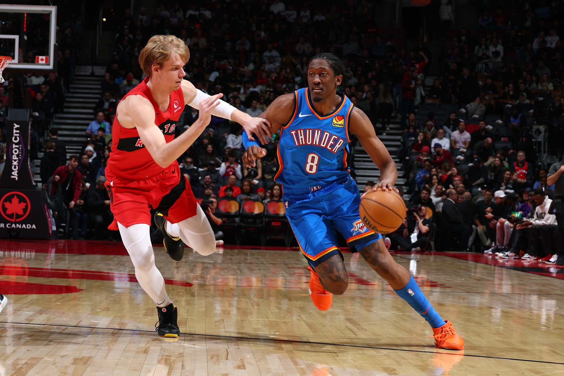 TORONTO, CANADA - DECEMBER 05: Jalen Williams #8 of the Oklahoma City Thunder drives to the basket during the game against the Toronto Raptors on December 5, 2024 at the Scotiabank Arena in Toronto, Ontario, Canada.  NOTE TO USER: User expressly acknowledges and agrees that, by downloading and or using this Photograph, user is consenting to the terms and conditions of the Getty Images License Agreement.  Mandatory Copyright Notice: Copyright 2024 NBAE (Photo by Vaughn Ridley/NBAE via Getty Images)