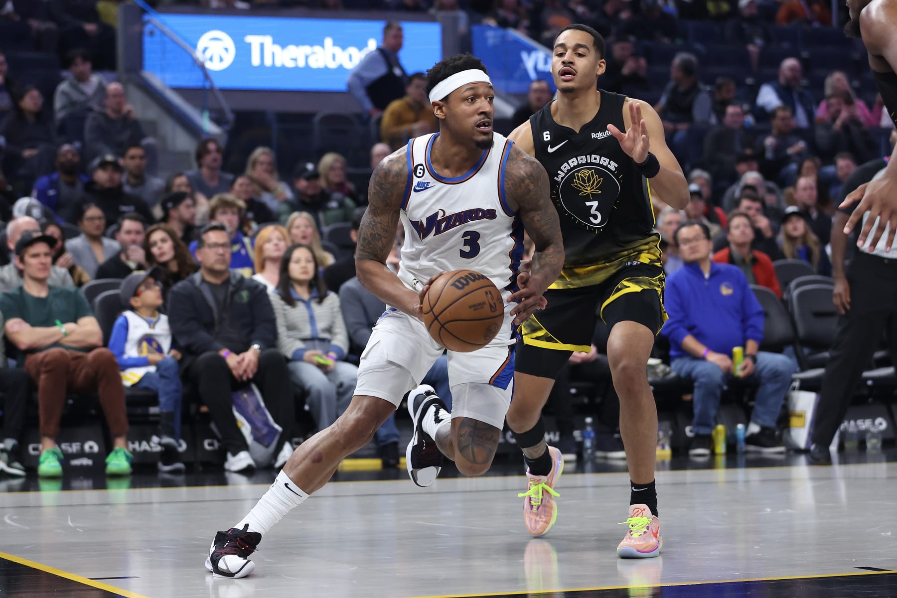 SAN FRANCISCO, CALIFORNIA - FEBRUARY 13: Bradley Beal #3 of the Washington Wizards drives to the basket against Jordan Poole #3 of the Golden State Warriors in the third quarter at Chase Center on February 13, 2023 in San Francisco, California. NOTE TO USER: User expressly acknowledges and agrees that, by downloading and/or using this photograph, User is consenting to the terms and conditions of the Getty Images License Agreement. (Photo by Lachlan Cunningham/Getty Images)
