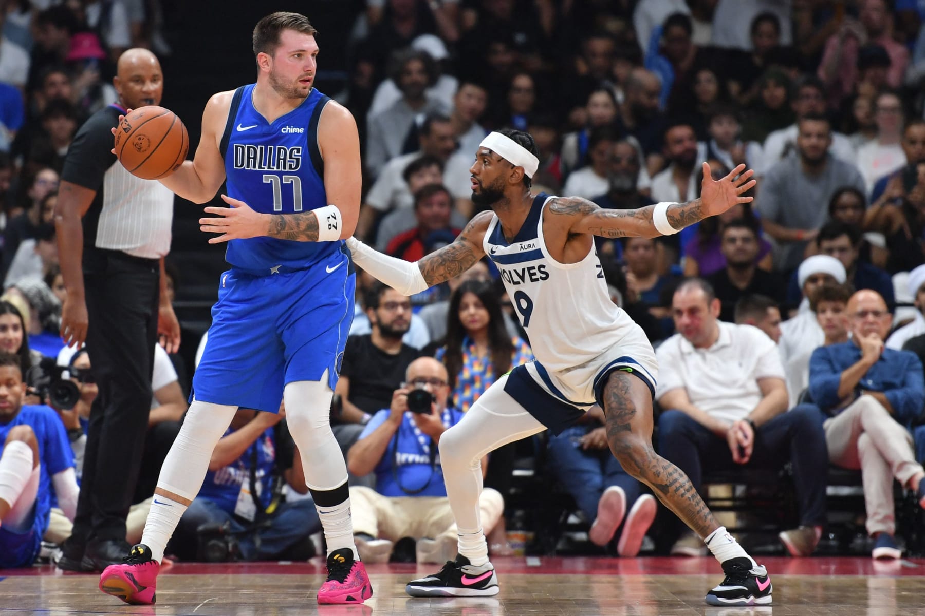Dallas Mavericks' guard Luka Doncic #77 is guarded by Minnesota Timberwolves' guard Nickeil Alexander-Walker #9 during the NBA Preseason game between the Dallas Mavericks and the Minnesota Timberwolves at the Etihad Arena in Abu Dhabi on October 7, 2023. (Photo by Ryan LIM / AFP) (Photo by RYAN LIM/AFP via Getty Images)