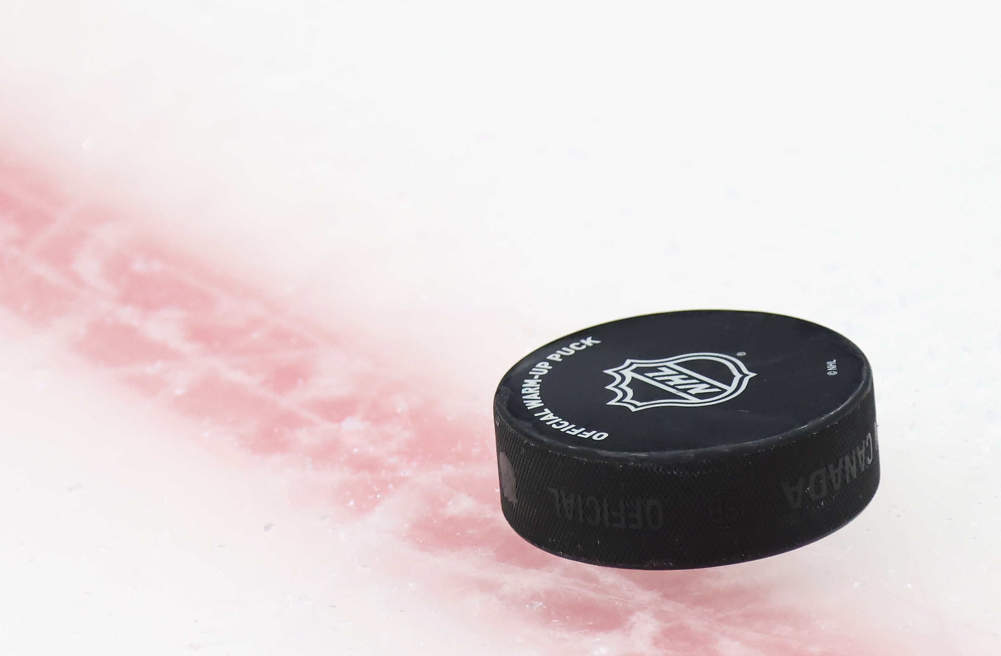 UNIONDALE, NEW YORK - MAY 20: A puck sits on the ice during warm-ups prior to the game between the New York Islanders and the Pittsburgh Penguins in Game Three of the First Round of the 2021 Stanley Cup Playoffs at the Nassau Coliseum on May 20, 2021 in Uniondale, New York. The Penguins defeated the Islanders 5-4. (Photo by Bruce Bennett/Getty Images)