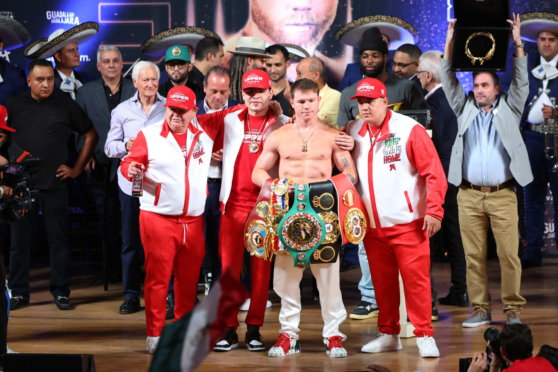 GUADALAJARA, MEXICO - MAY 05: Canelo Alvarez poses with his belts and team during a ceremonial weigh-in on May 05, 2023 in Guadalajara, Mexico. Alvarez will face John Ryder for their undisputed super middleweight championship bout at Akron Stadium on May 06. (Photo by Hector Vivas/Getty Images)