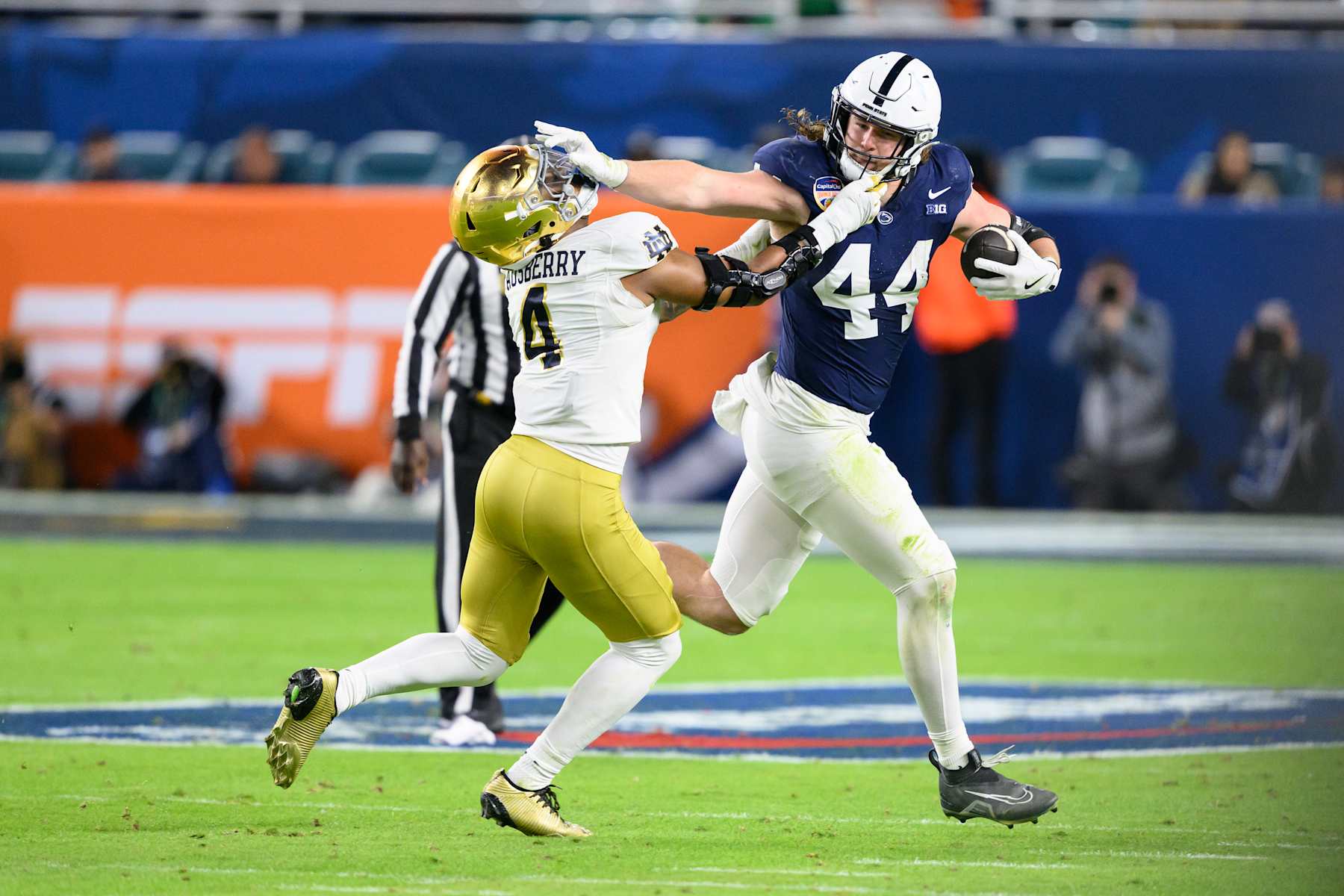 MIAMI GARDENS, FL - JANUARY 09: Tight End Tyler Warren #44 of the Penn State Nittany Lions runs with the ball and stiff arms Linebacker Jaiden Ausberry #4 of the Notre Dame Fighting Irish during the Penn State Nittany Lions versus Notre Dame Fighting Irish College Football Playoff Semifinal at the Capital One Orange Bowl on January 9, 2025, at Hard Rock Stadium in Miami Gardens, FL. (Photo by Doug Murray/Icon Sportswire via Getty Images)