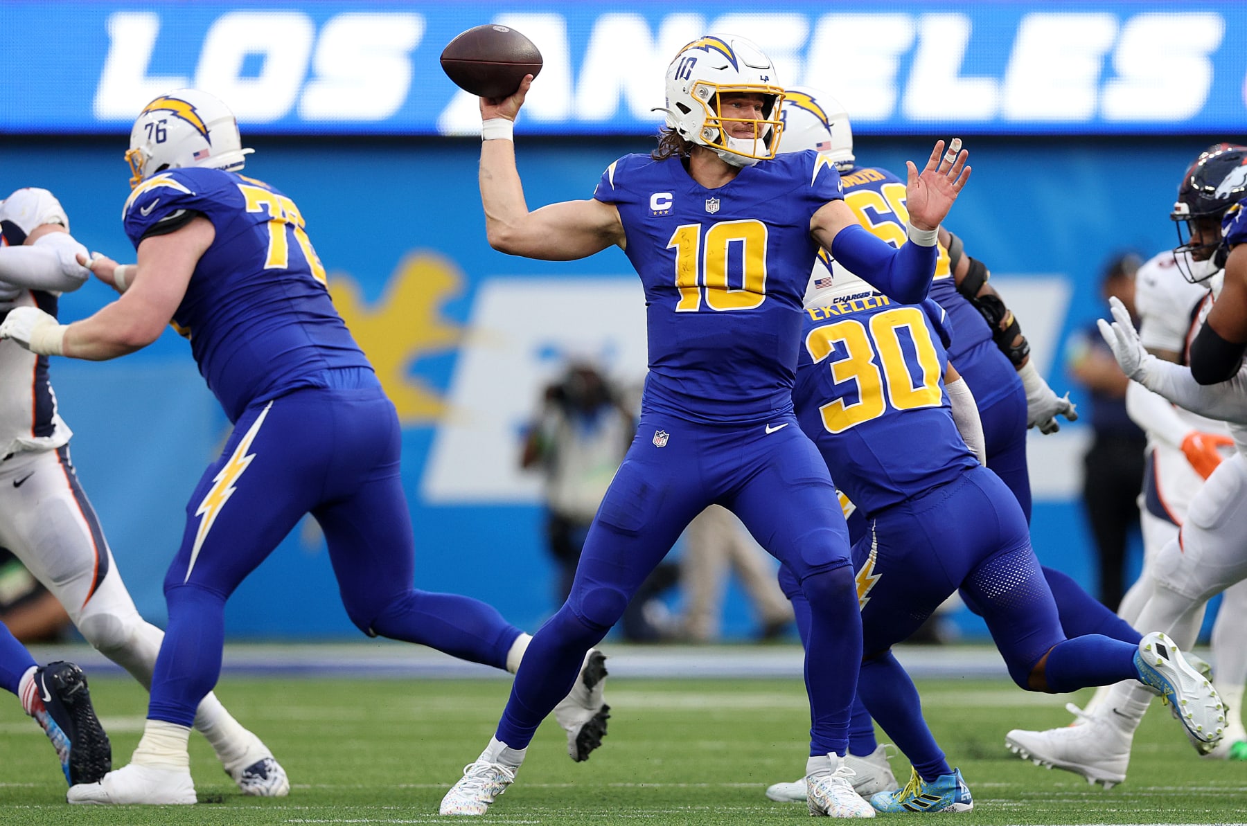 INGLEWOOD, CALIFORNIA - DECEMBER 10: Justin Herbert #10 of the Los Angeles Chargers throws a pass during the second quarter against the Denver Broncos at SoFi Stadium on December 10, 2023 in Inglewood, California. (Photo by Harry How/Getty Images)
