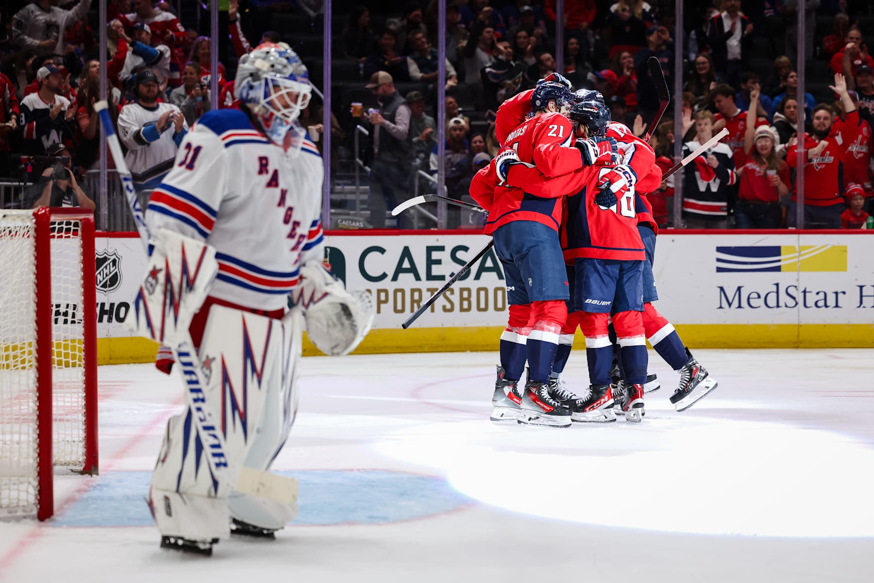 WASHINGTON, DC - OCTOBER 29: Aliaksei Protas #21 of the Washington Capitals celebrates with Trevor van Riemsdyk #57, Rasmus Sandin #38, and Dylan Strome #17 after scoring a goal against Igor Shesterkin #31 of the New York Rangers during the second period of the game at Capital One Arena on October 29, 2024 in Washington, DC. (Photo by Scott Taetsch/Getty Images)