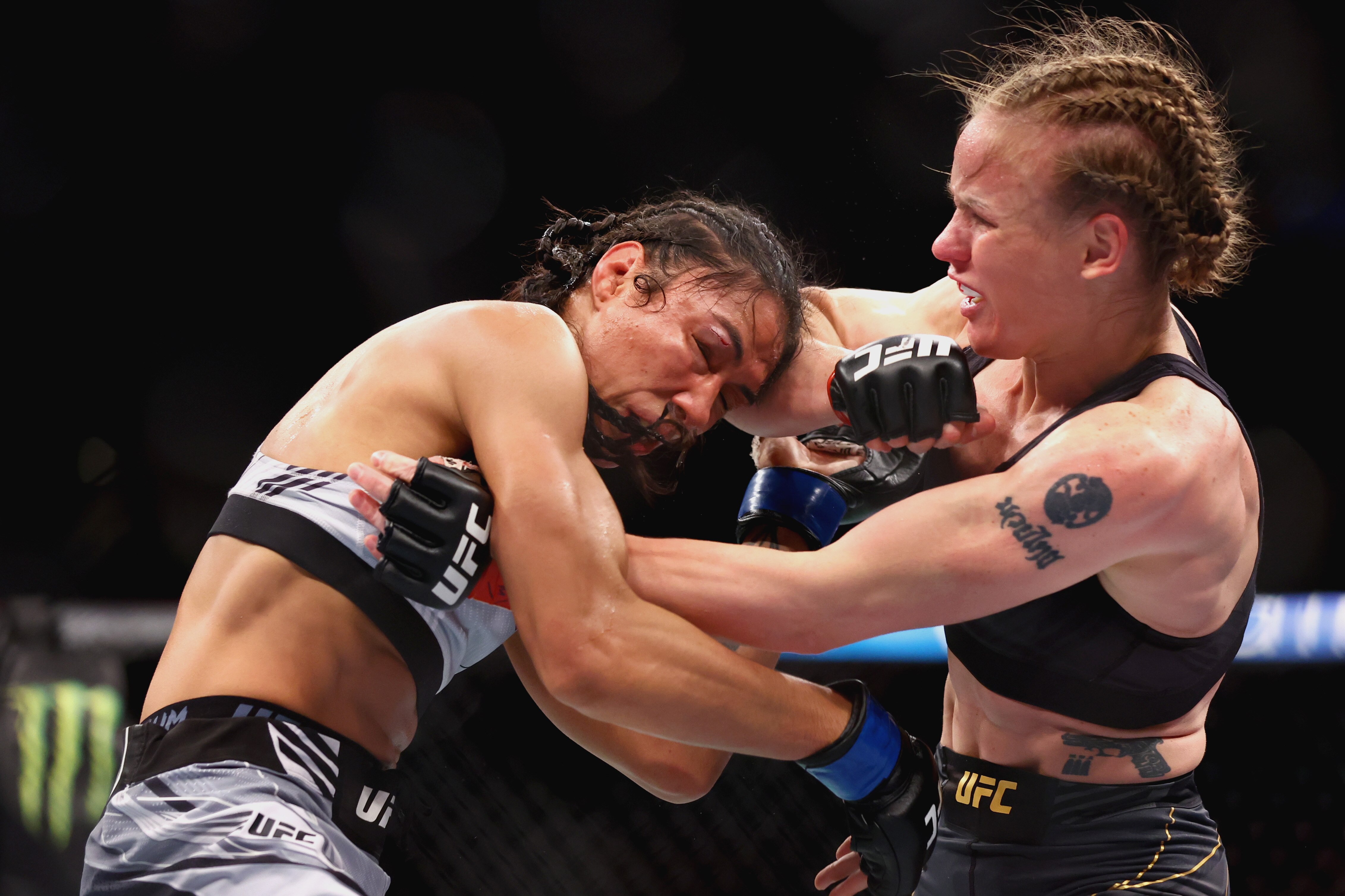SINGAPORE, SINGAPORE - JUNE 12: Valentina Shevchenko of Kyrgyzstan exchanges strikes with Taila Santos of Brazil during their Women's Flyweight Fight at Singapore Indoor Stadium on June 12, 2022 in Singapore. (Photo by Yong Teck Lim/Getty Images)