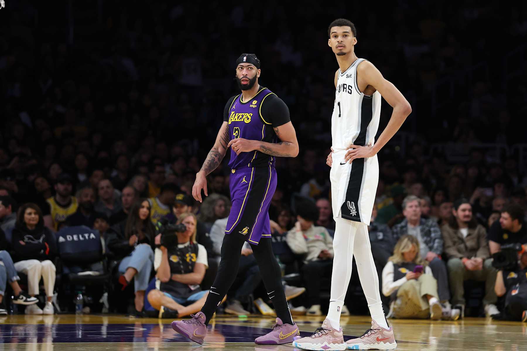LOS ANGELES, CALIFORNIA - FEBRUARY 23: Victor Wembanyama #1 of the San Antonio Spurs stands next to Anthony Davis #3 of the Los Angeles Lakers during the second half of a game  at Crypto.com Arena on February 23, 2024 in Los Angeles, California. NOTE TO USER: User expressly acknowledges and agrees that, by downloading and or using this photograph, User is consenting to the terms and conditions of the Getty Images License Agreement. (Photo by Sean M. Haffey/Getty Images)