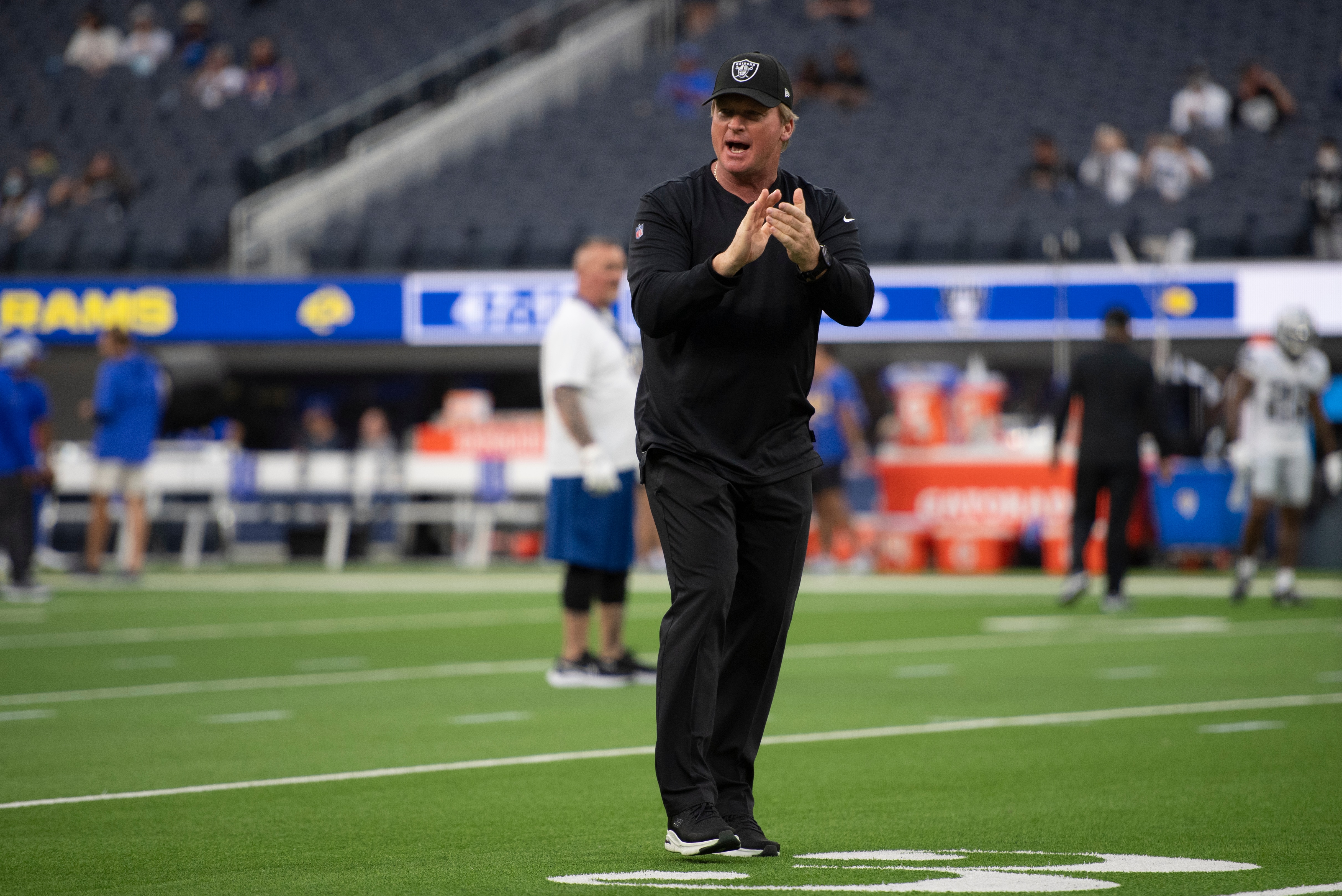 Las Vegas Raiders head coach Jon Gruden greets players entering to warm up before an NFL preseason football game against the Los Angeles Rams Saturday, Aug. 21, 2021, in Inglewood, Calif. (AP Photo/Kyusung Gong)