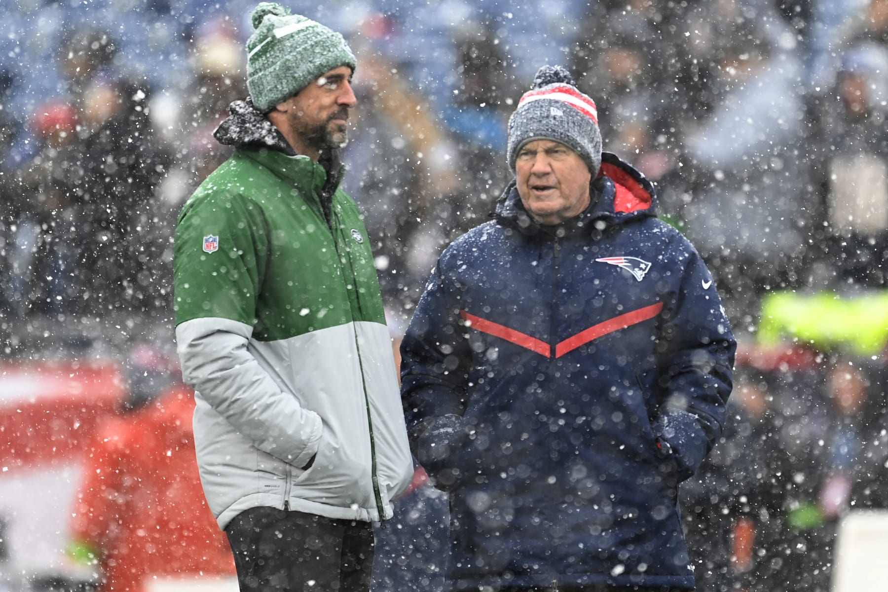 FOXBOROUGH, MASSACHUSETTS - JANUARY 7: Head coach Bill Belichick of the New England Patriots talks with Aaron Rodgers #9 of the New York Jets before the game at Gillette Stadium on January 7, 2024 in Foxborough, Massachusetts. (Photo by Billie Weiss/Getty Images)