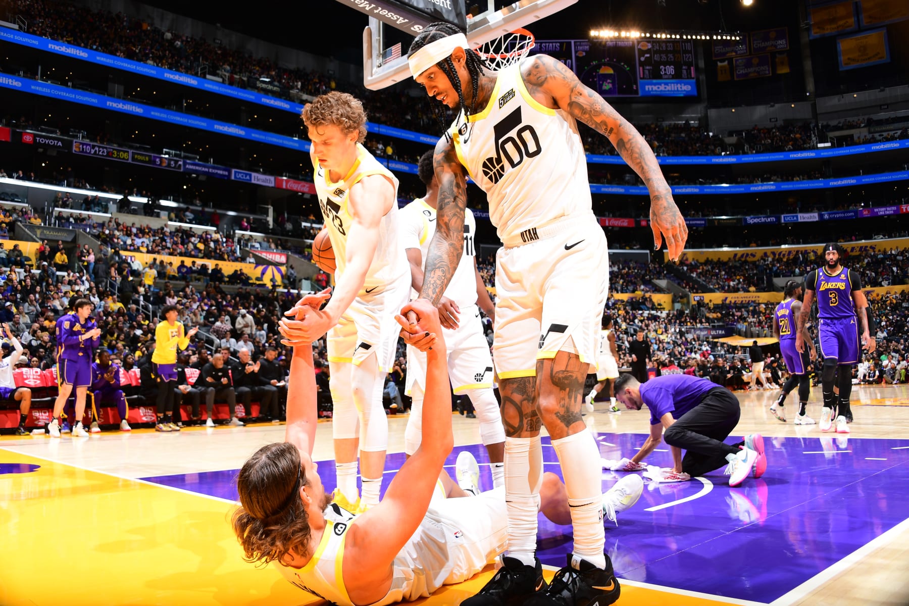 LOS ANGELES, CA - NOVEMBER 4: Lauri Markkanen #23 and Jordan Clarkson #00 help up Kelly Olynyk #41 of the Utah Jazz during the game against the Los Angeles Lakers on November 4, 2022 at Crypto.Com Arena in Los Angeles, California. NOTE TO USER: User expressly acknowledges and agrees that, by downloading and/or using this Photograph, user is consenting to the terms and conditions of the Getty Images License Agreement. Mandatory Copyright Notice: Copyright 2022 NBAE (Photo by Adam Pantozzi/NBAE via Getty Images)