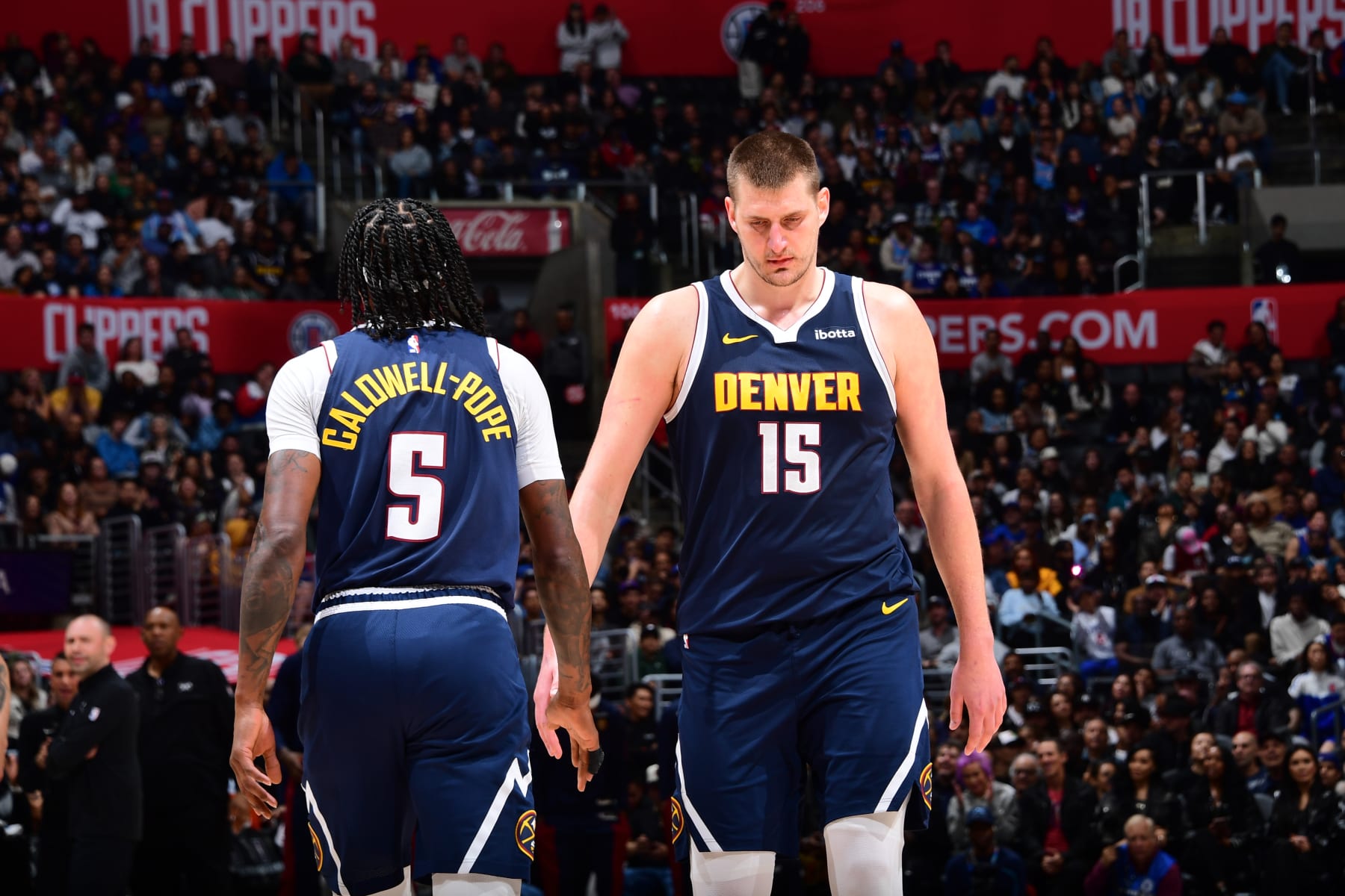 LOS ANGELES, CA - APRIL 4: Kentavious Caldwell-Pope #5 and Nikola Jokic #15 of the Denver Nuggets look on during the game against the LA Clippers on April 4, 2024 at Crypto.Com Arena in Los Angeles, California. NOTE TO USER: User expressly acknowledges and agrees that, by downloading and/or using this Photograph, user is consenting to the terms and conditions of the Getty Images License Agreement. Mandatory Copyright Notice: Copyright 2024 NBAE (Photo by Adam Pantozzi/NBAE via Getty Images)