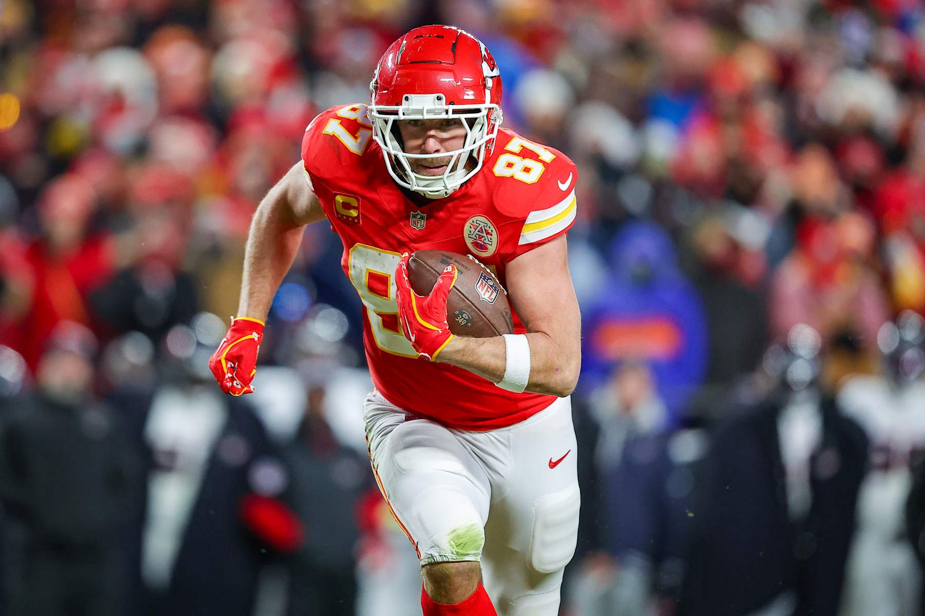 KANSAS CITY, MISSOURI - JANUARY 18: Travis Kelce #87 of the Kansas City Chiefs runs for yardage after a third quarter pass catch in the Divisional Round playoff at GEHA Field at Arrowhead Stadium on January 18, 2025 in Kansas City, Missouri. (Photo by David Eulitt/Getty Images)