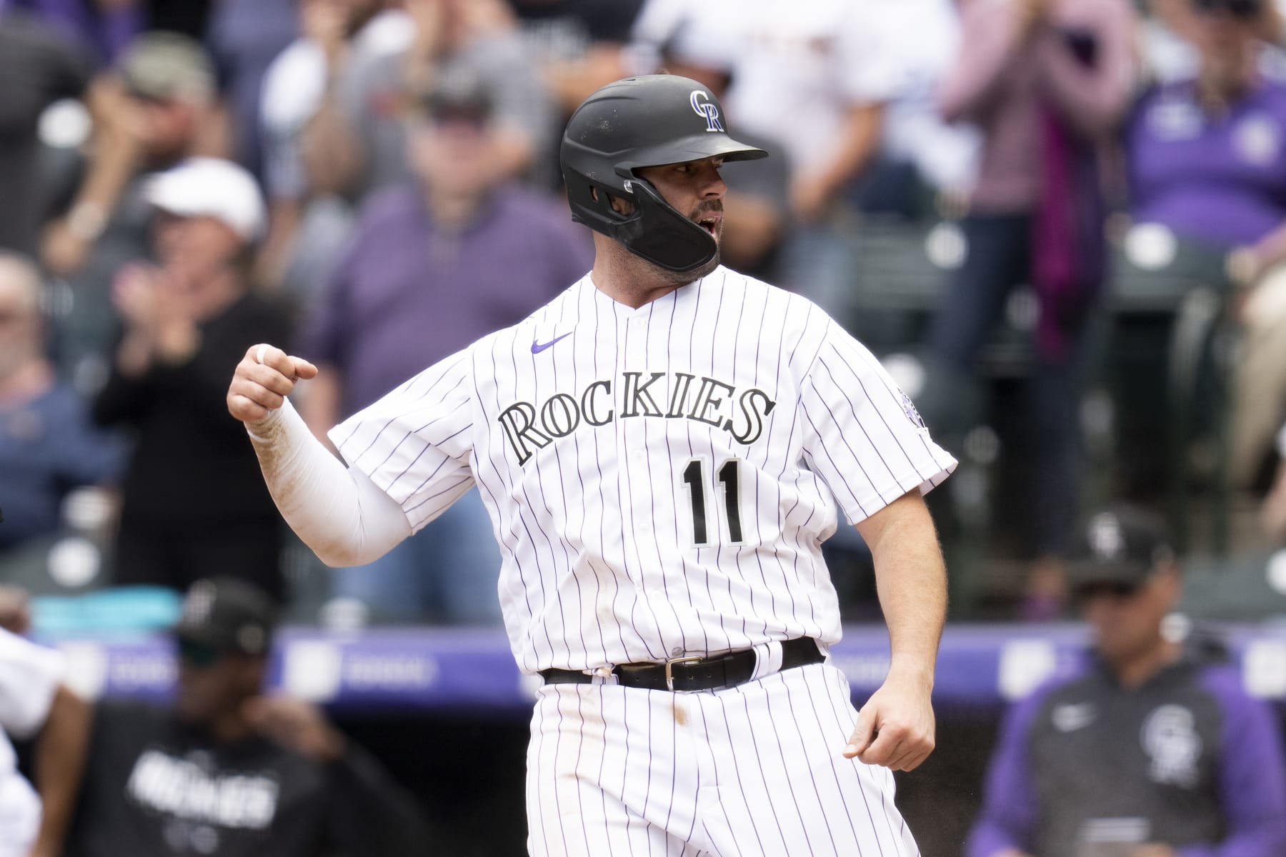 DENVER, CO - MAY 4: Mike Moustakas #11 of the Colorado Rockies reacts after scoring during the eighth inning of a game against the Milwaukee Brewers at Coors Field on May 4, 2023 in Denver, Colorado.
