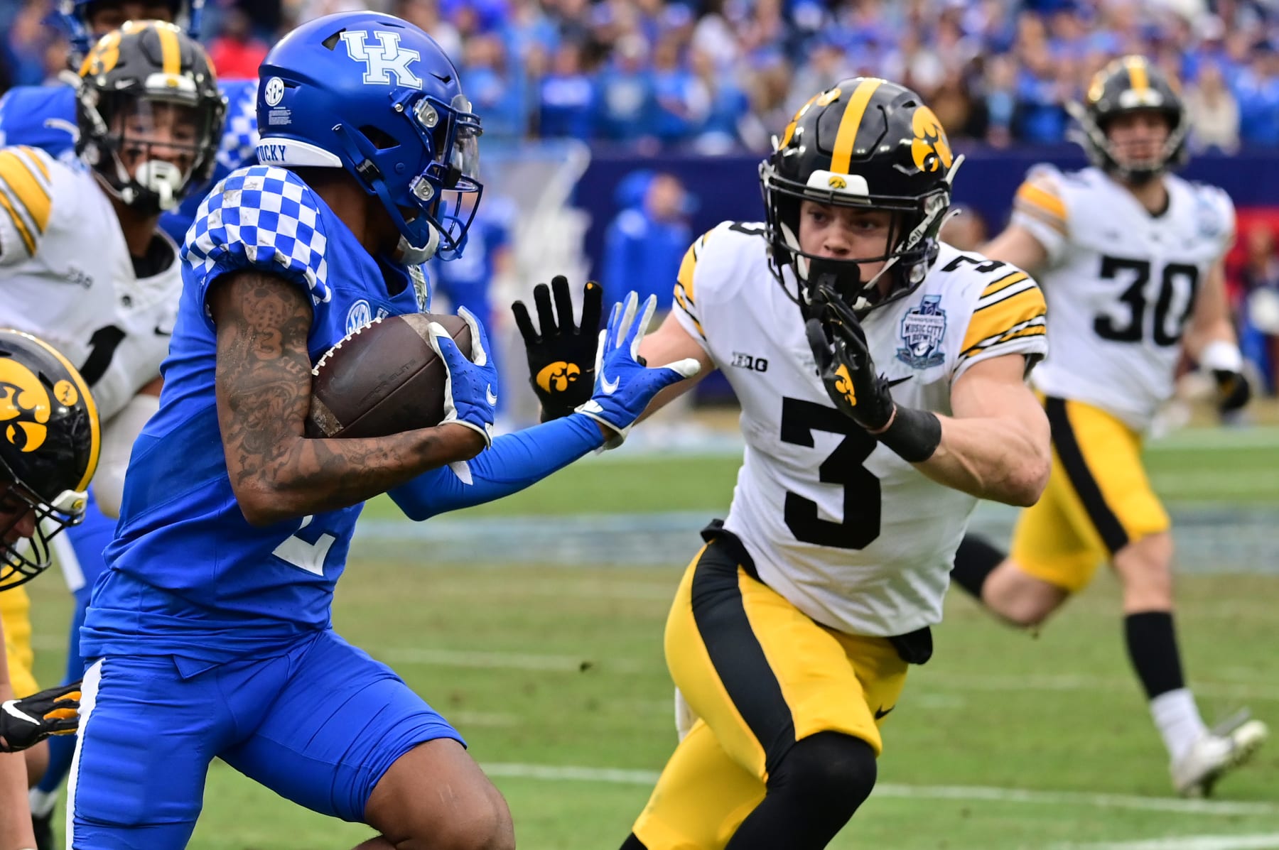 NASHVILLE, TN - DECEMBER 31: Iowa left cornerback Cooper DeJean (3) goes after Kentucky wide receiver Marion Brown (2) during the TransPerfect Music City Bowl game between the Kentucky Wildcats and the Iowa Hawkeyes on December 31, 2022, at Nissan Stadium in Nashville, TN (Photo by Keith Gillett/Icon Sportswire via Getty Images)