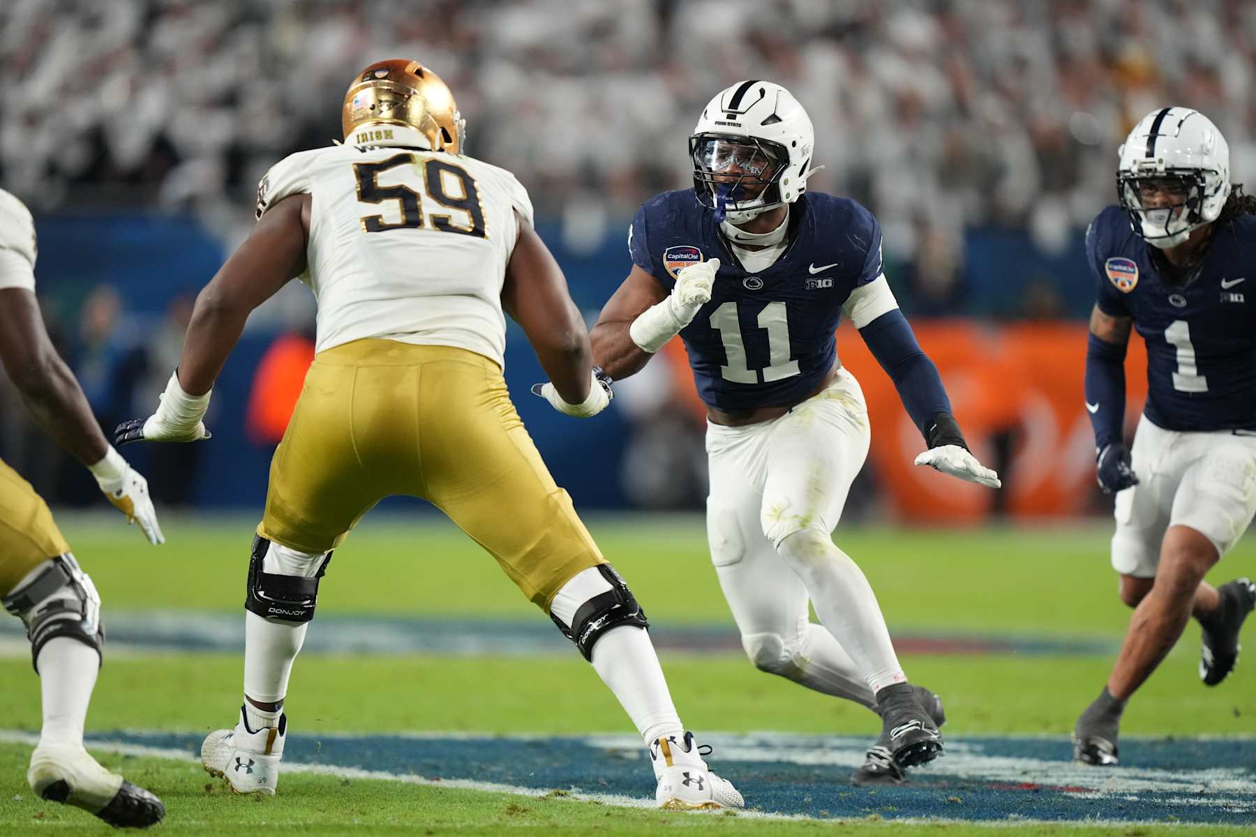MIAMI GARDENS, FL - JANUARY 09: Penn State Nittany Lions defensive end Abdul Carter (11) rushes the passer during the Penn State Nittany Lions versus Notre Dame Fighting Irish College Football Playoff Semifinal at the Capital One Orange Bowl on January 9, 2025, at Hard Rock Stadium in Miami Gardens, FL. (Photo by Peter Joneleit/Icon Sportswire via Getty Images)