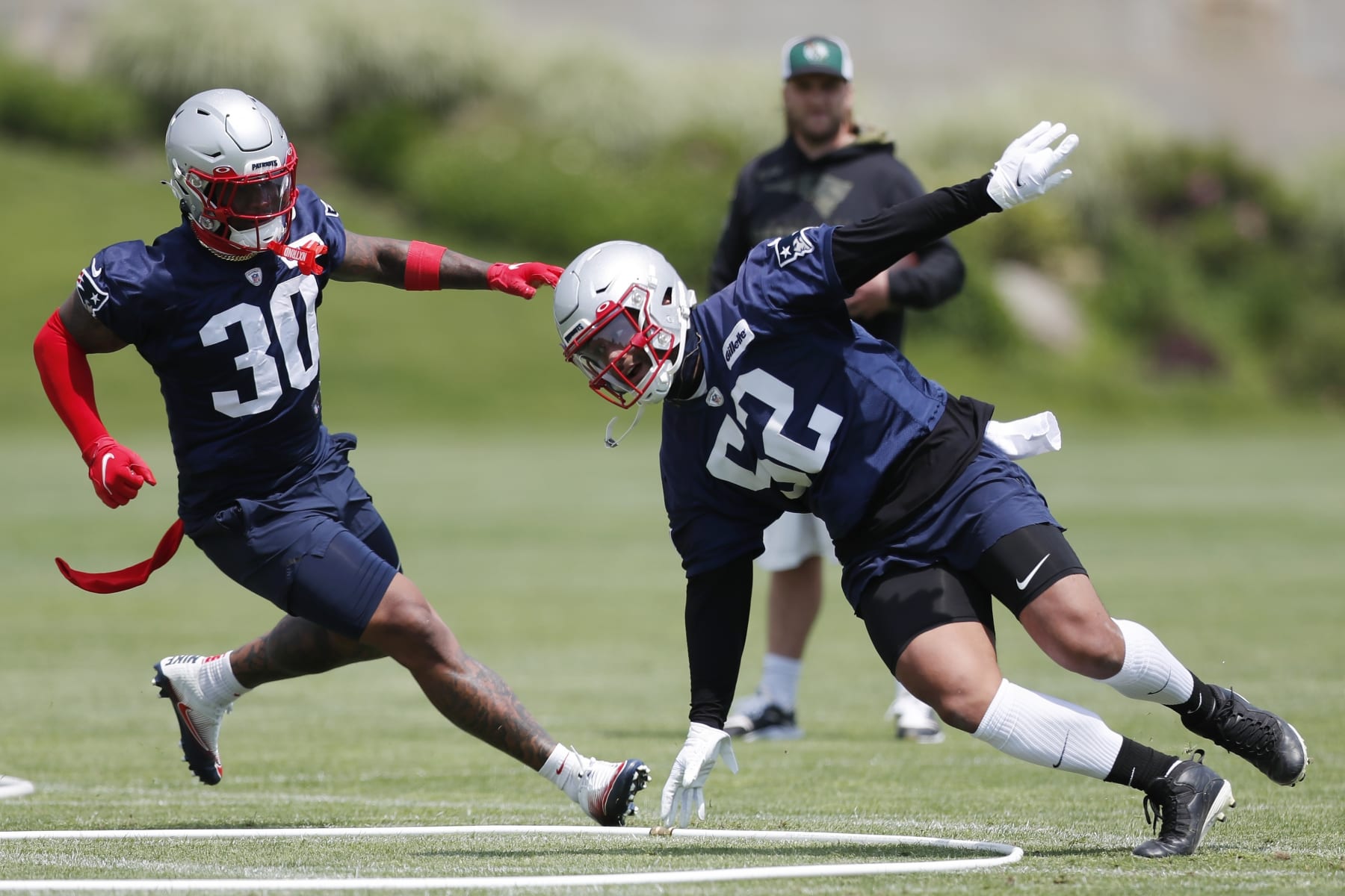 New England Patriots defensive back Marcus Jones (52) and linebacker Mack Wilson Sr. (30) take part in drills at the NFL football team's practice facility in Foxborough, Mass., Tuesday, May 31, 2022 (AP Photo/Michael Dwyer)