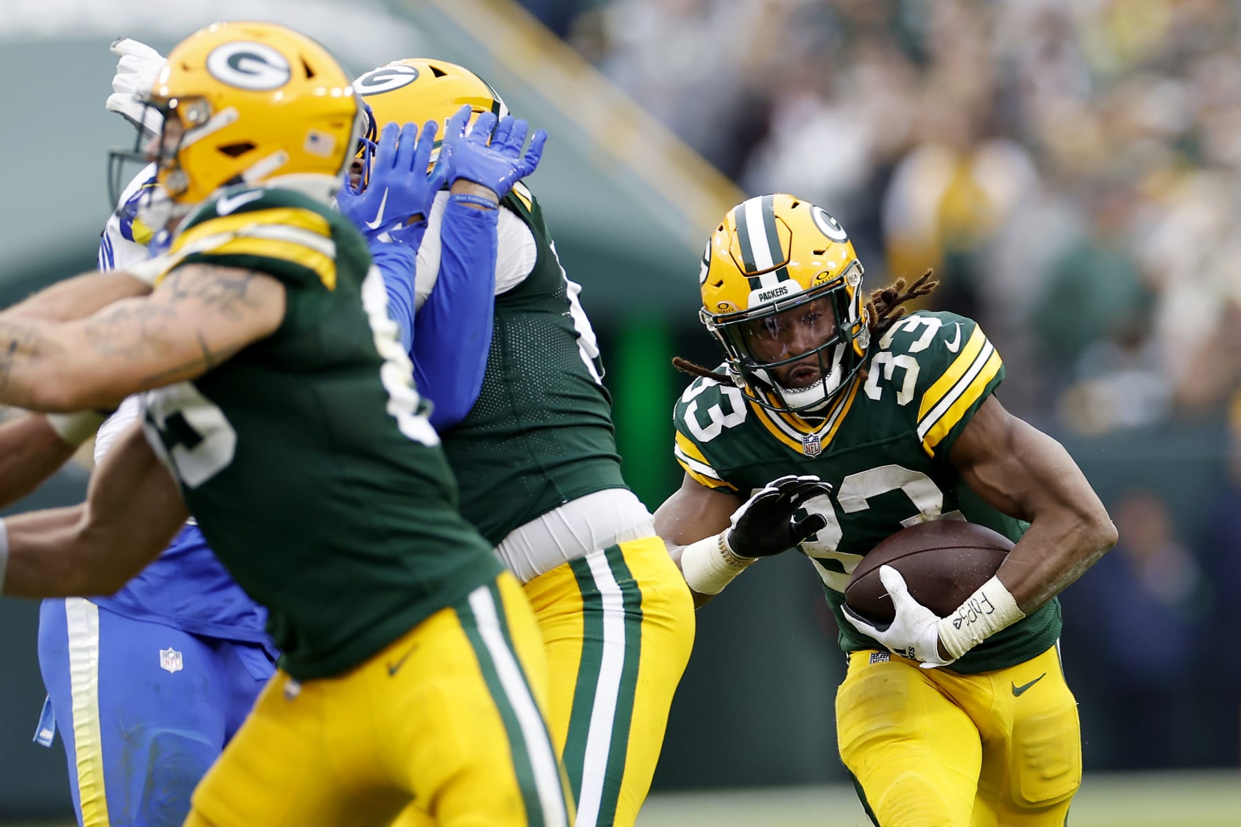 GREEN BAY, WISCONSIN - NOVEMBER 05: Aaron Jones #33 of the Green Bay Packers runs the ball up the field in the fourth quarter of a game against the Los Angeles Rams at Lambeau Field on November 05, 2023 in Green Bay, Wisconsin. (Photo by John Fisher/Getty Images)
