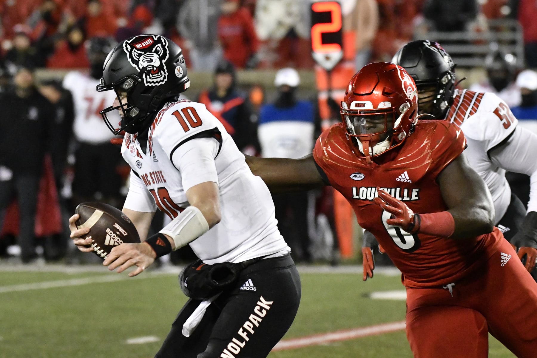 Louisville defensive lineman YaYa Diaby (6) attempts to grab North Carolina State quarterback Ben Finley (10) during the second half of an NCAA college football game in Louisville, Ky., Saturday, Nov. 19, 2022. (AP Photo/Timothy D. Easley)