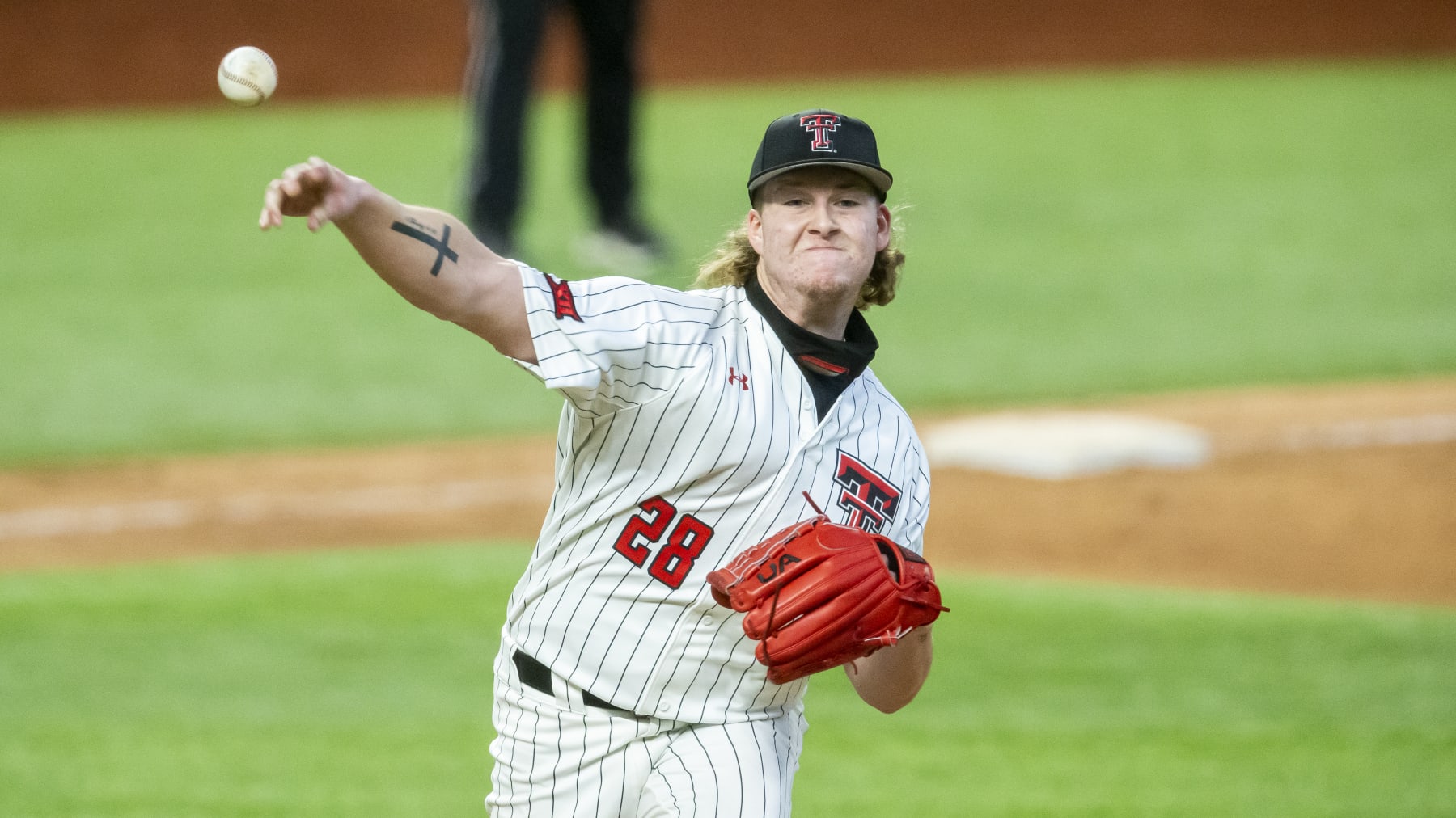 Texas Tech pitcher Chase Hampton (28) throws to first in an attempt to force out Mississippi State's Rowdey Jordan (4) during an NCAA baseball game on Monday, Feb. 22, 2021, in Arlington, Texas. Mississippi State won 11-5. (AP Photo/Brandon Wade)