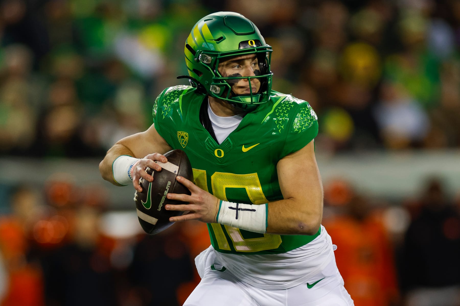 EUGENE, OREGON - NOVEMBER 24: Bo Nix #10 of the Oregon Ducks rolls out to pass during a game against the Oregon State Beavers at Autzen Stadium on November 24, 2023 in Eugene, Oregon. (Photo by Brandon Sloter/Image Of Sport/Getty Images) EUGENE, OREGON - NOVEMBER 24: Bo Nix #10 of the Oregon Ducks rolls out to pass during a game against the Oregon State Beavers at Autzen Stadium on November 24, 2023 in Eugene, Oregon. (Photo by Brandon Sloter/Image Of Sport/Getty Images)