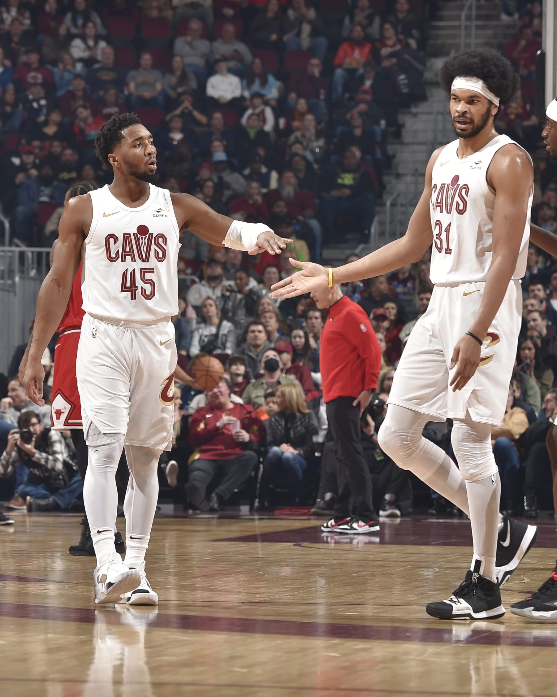 CLEVELAND, OH - JANUARY 15: Donovan Mitchell #45 high fives Jarrett Allen #31 of the Cleveland Cavaliers during the game against the Chicago Bulls on January 15, 2024 at Rocket Mortgage FieldHouse in Cleveland, Ohio. NOTE TO USER: User expressly acknowledges and agrees that, by downloading and/or using this Photograph, user is consenting to the terms and conditions of the Getty Images License Agreement. Mandatory Copyright Notice: Copyright 2024 NBAE (Photo by David Liam Kyle/NBAE via Getty Images)