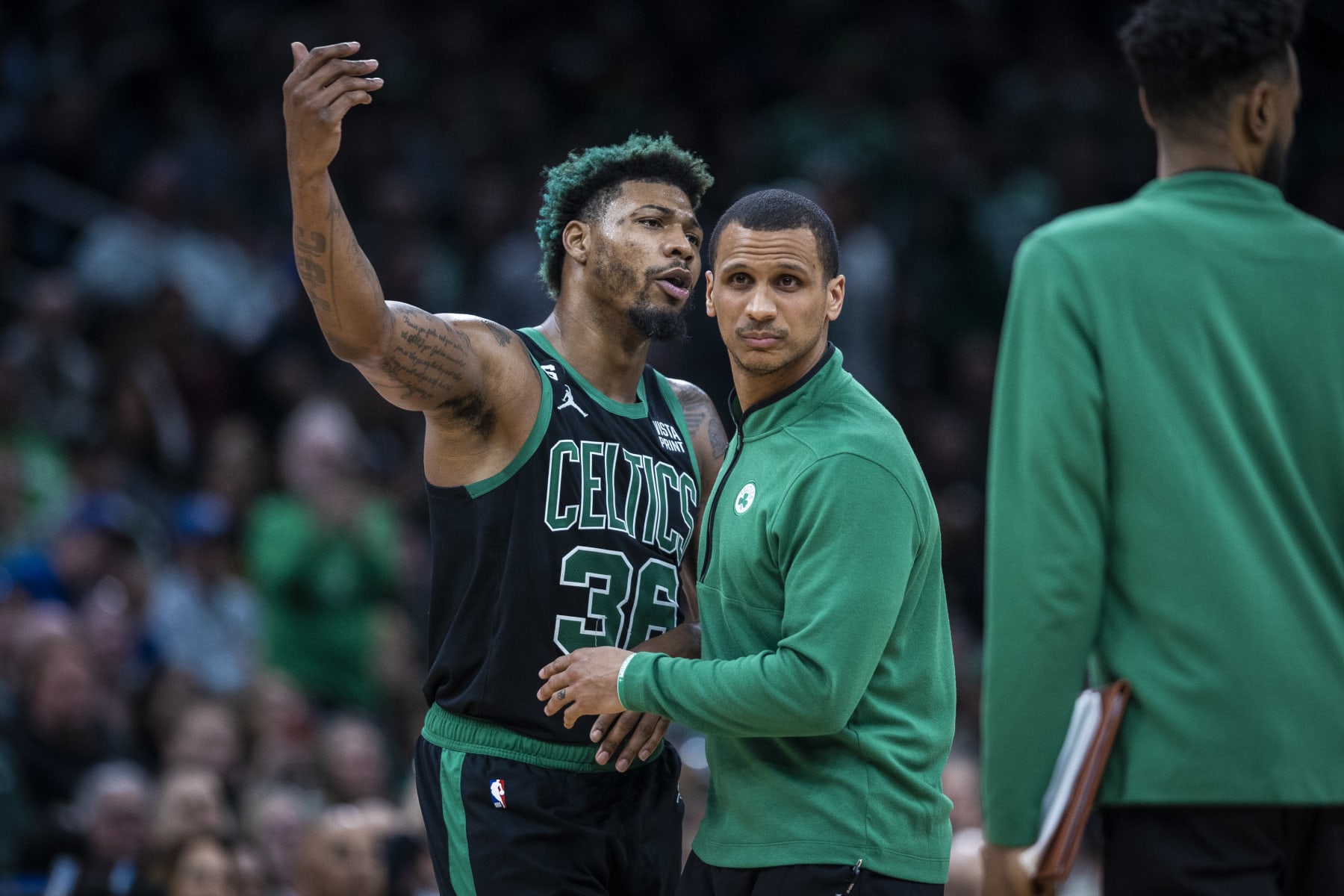 Boston, MA - March 31: Boston Celtics PG Marcus Smart has to be held back by head coach Joe Mazzulla after an altercation with Utah Jazz G Kris Dunn. The Celtics beat the Jazz, 122-114. (Photo by Erin Clark/The Boston Globe via Getty Images)